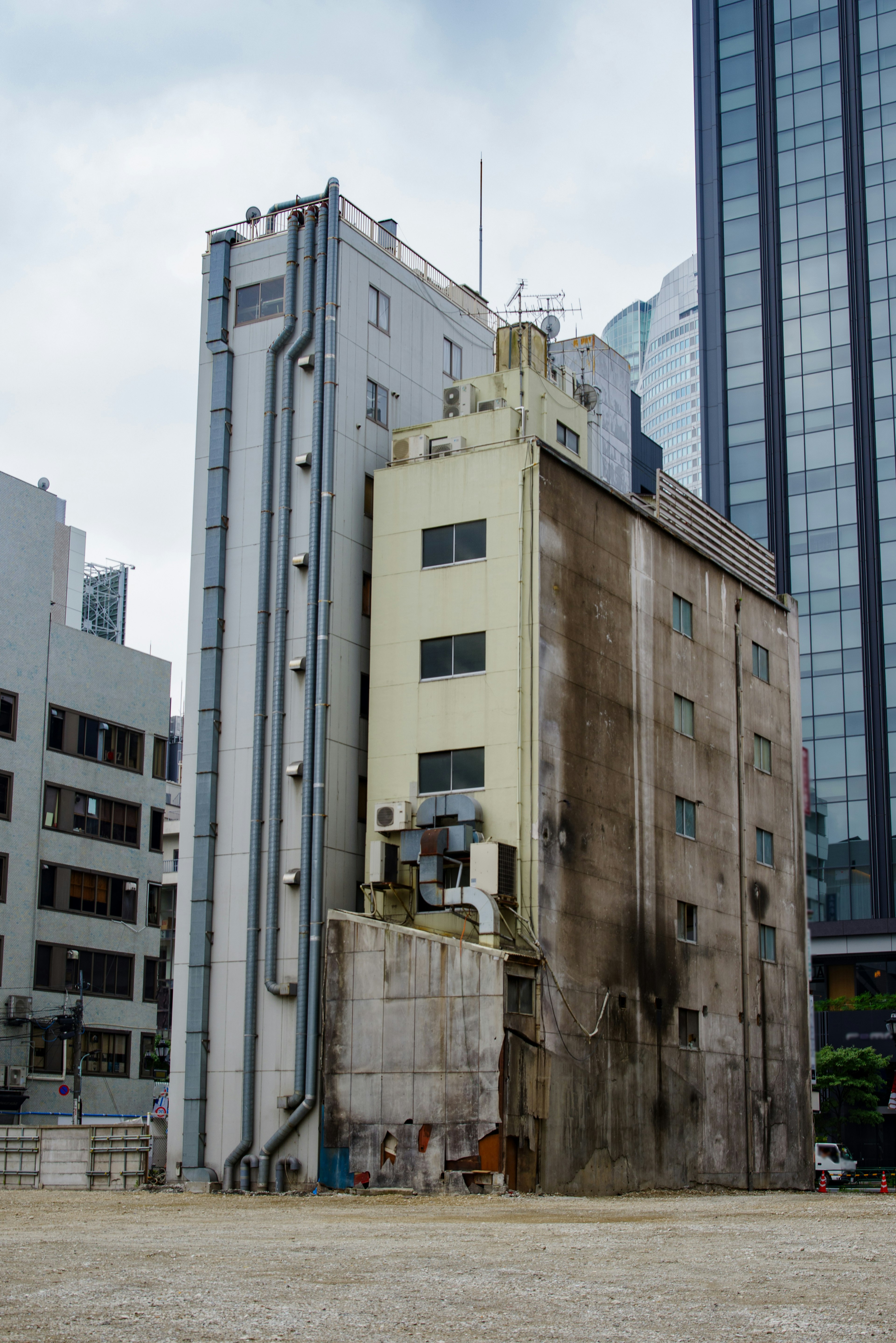 View of an old building side surrounded by skyscrapers