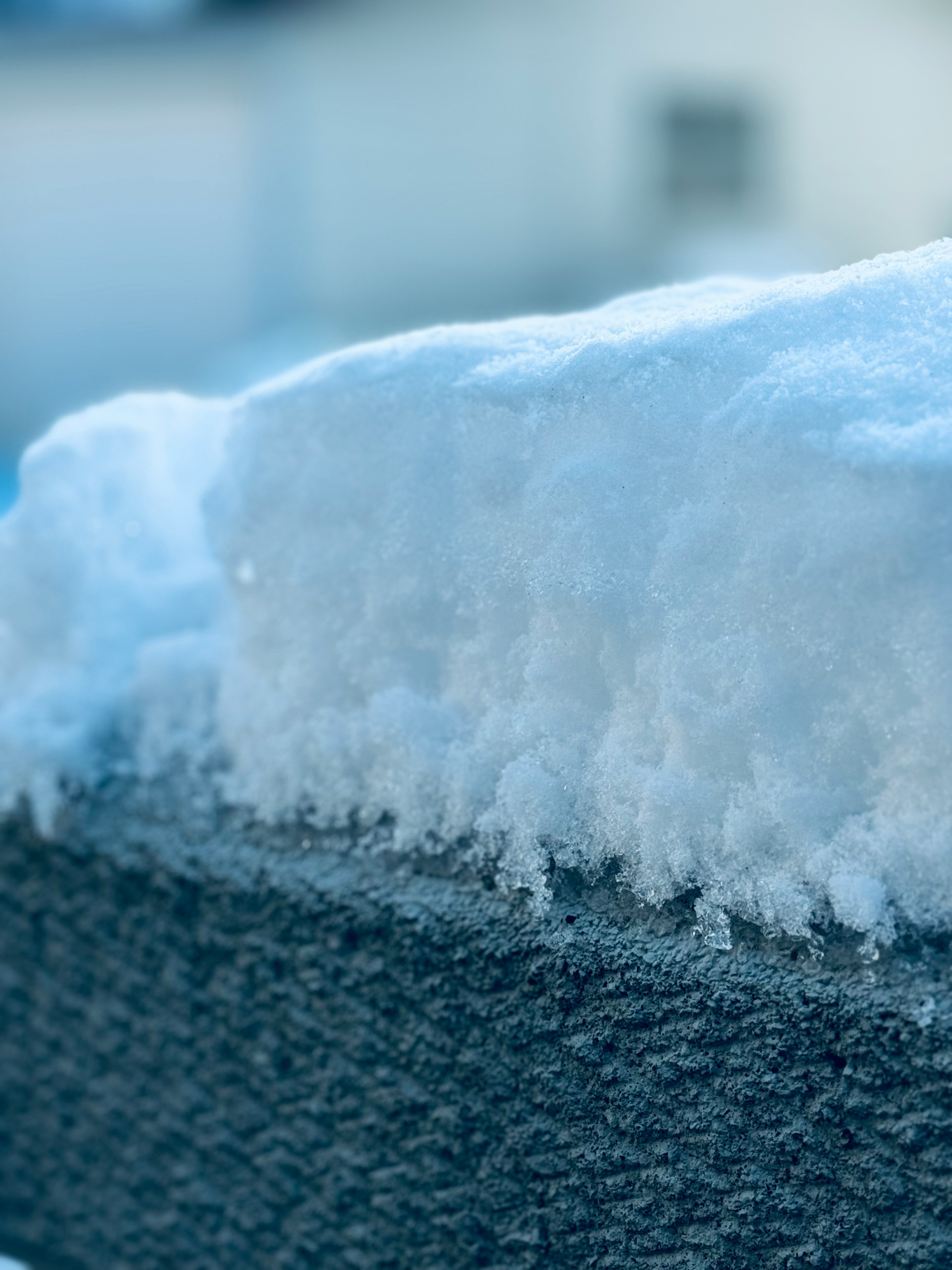 Close-up of snow accumulated on the edge of a roof