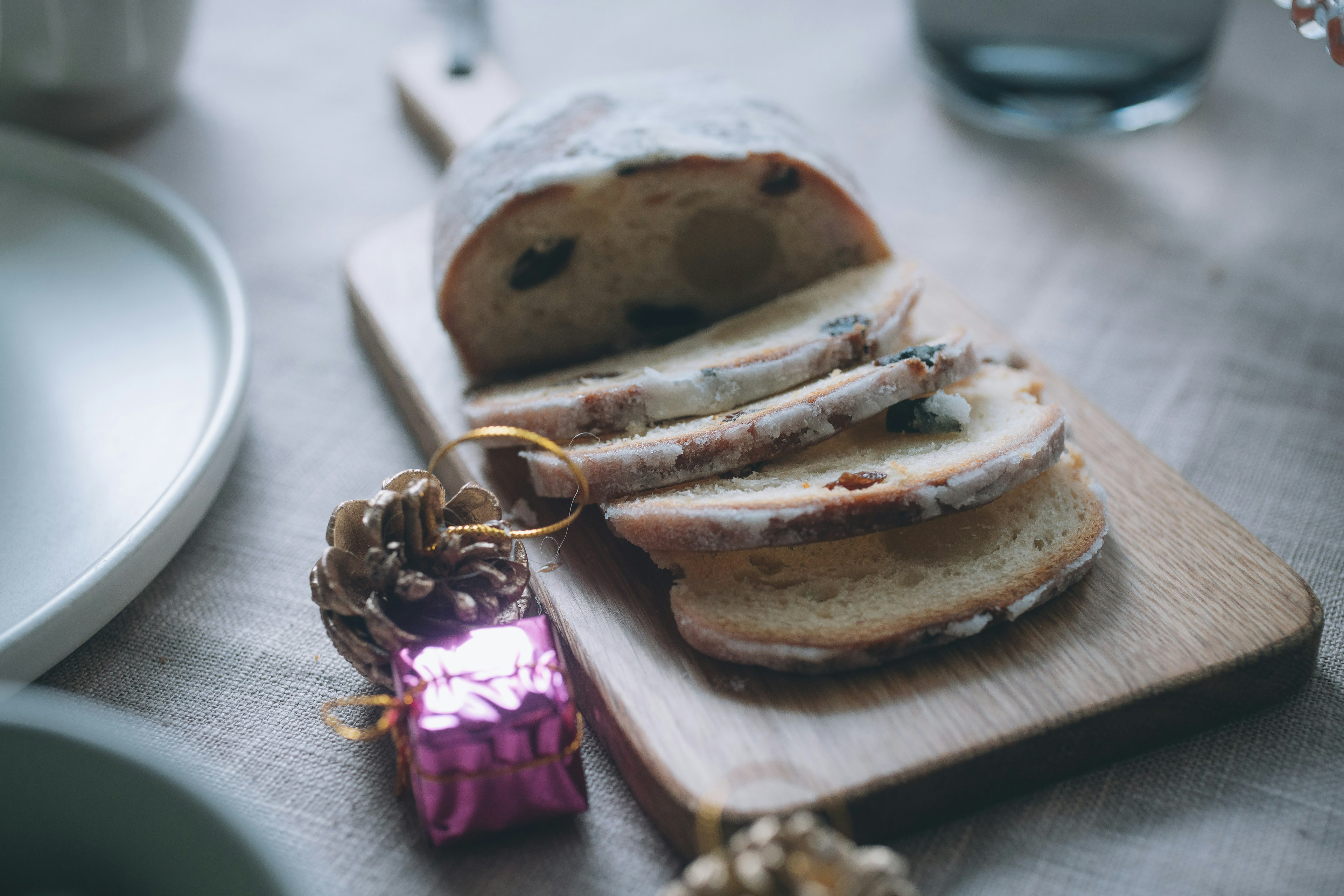 Stollen yang diiris di atas papan kayu dengan elemen dekoratif