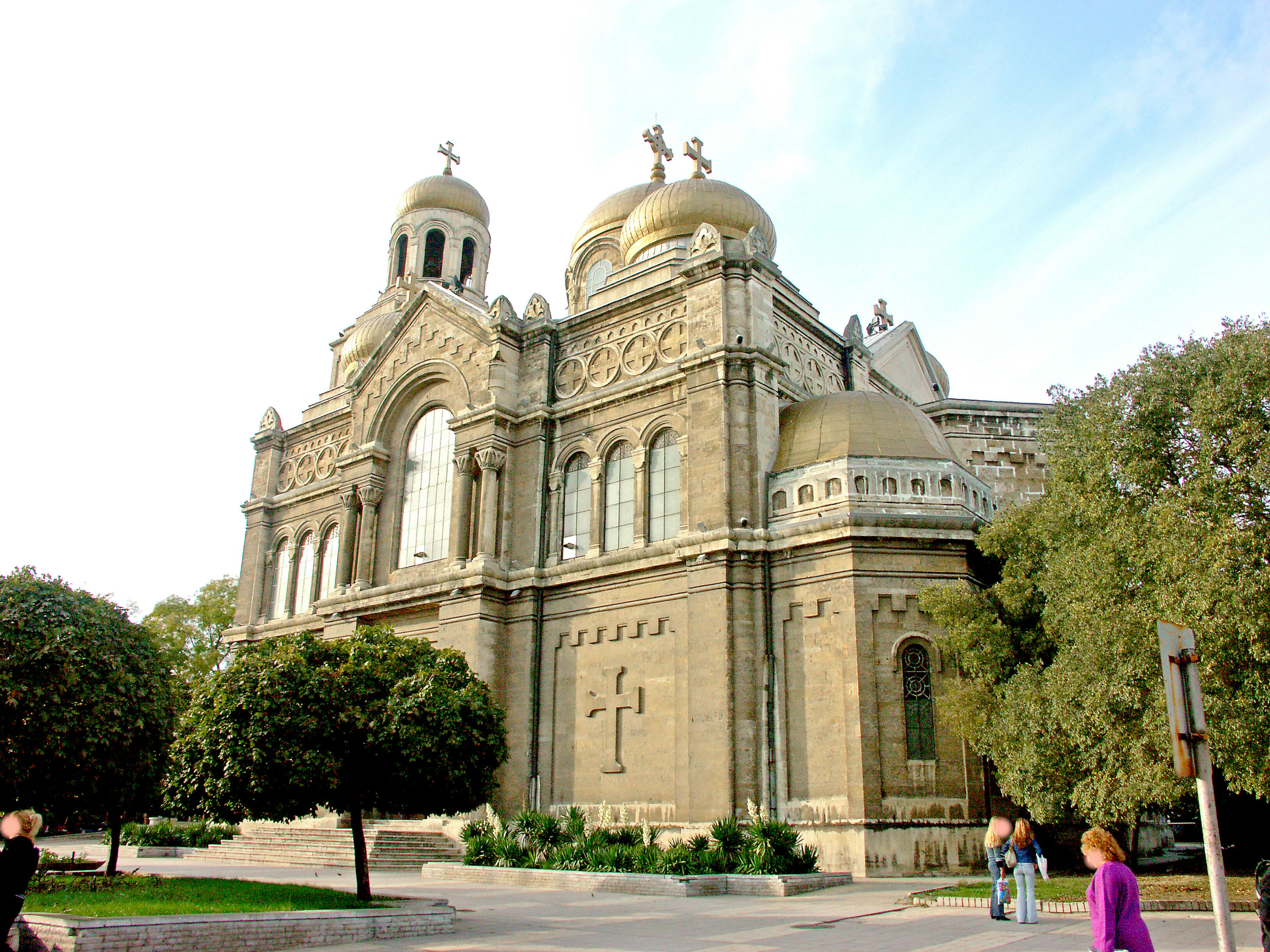 A beautiful cathedral exterior featuring golden domes and ornate façade