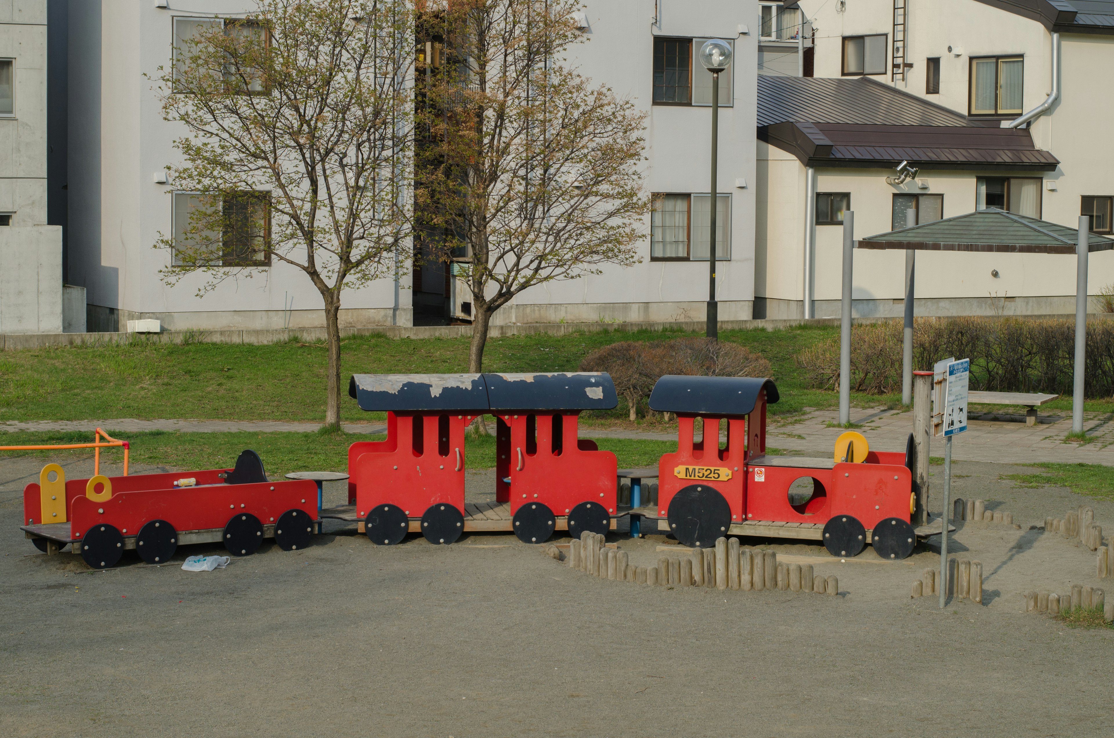 Un conjunto de tren de juegos rojo y vagón en un parque