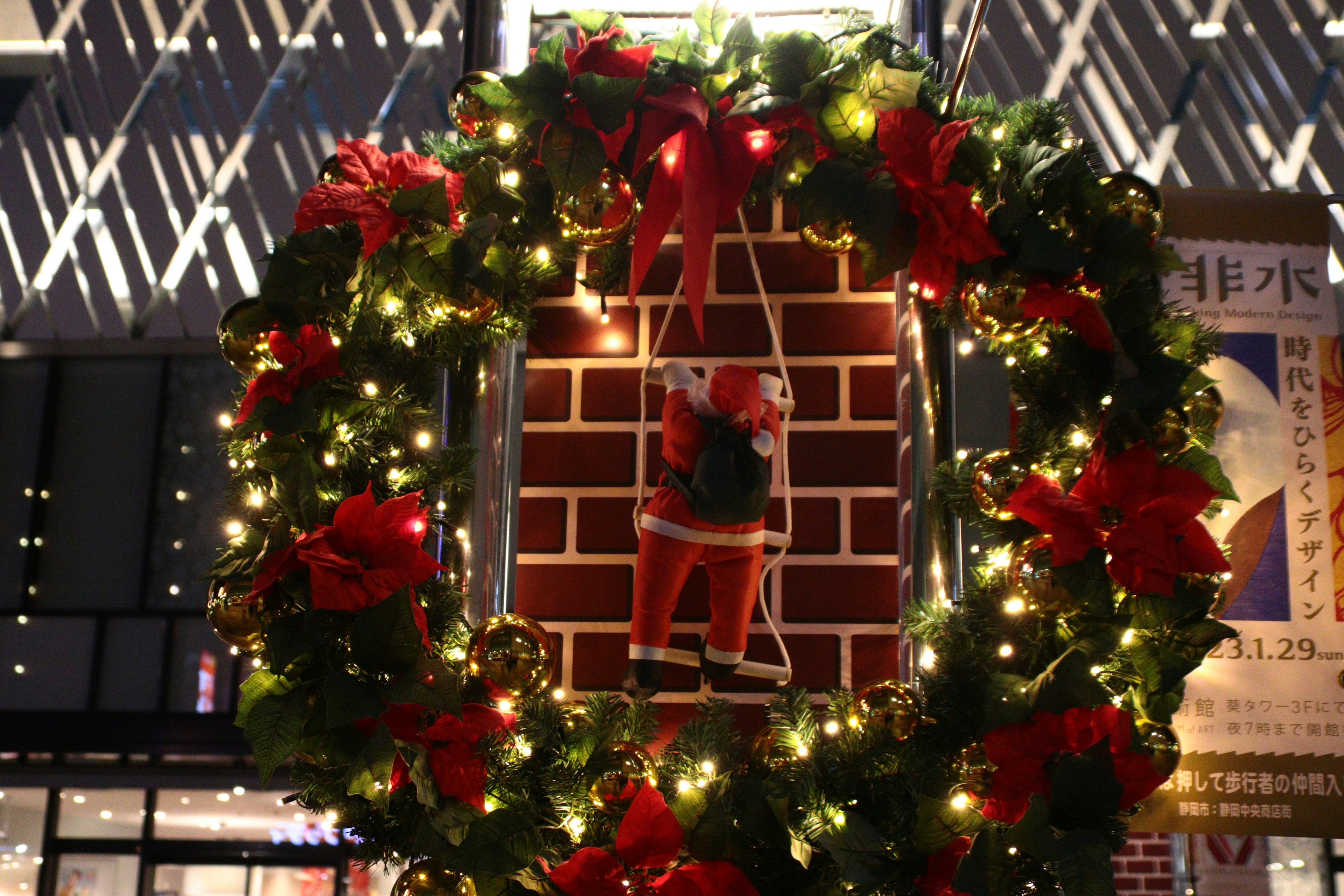 Christmas wreath with Santa Claus decoration and red ribbons