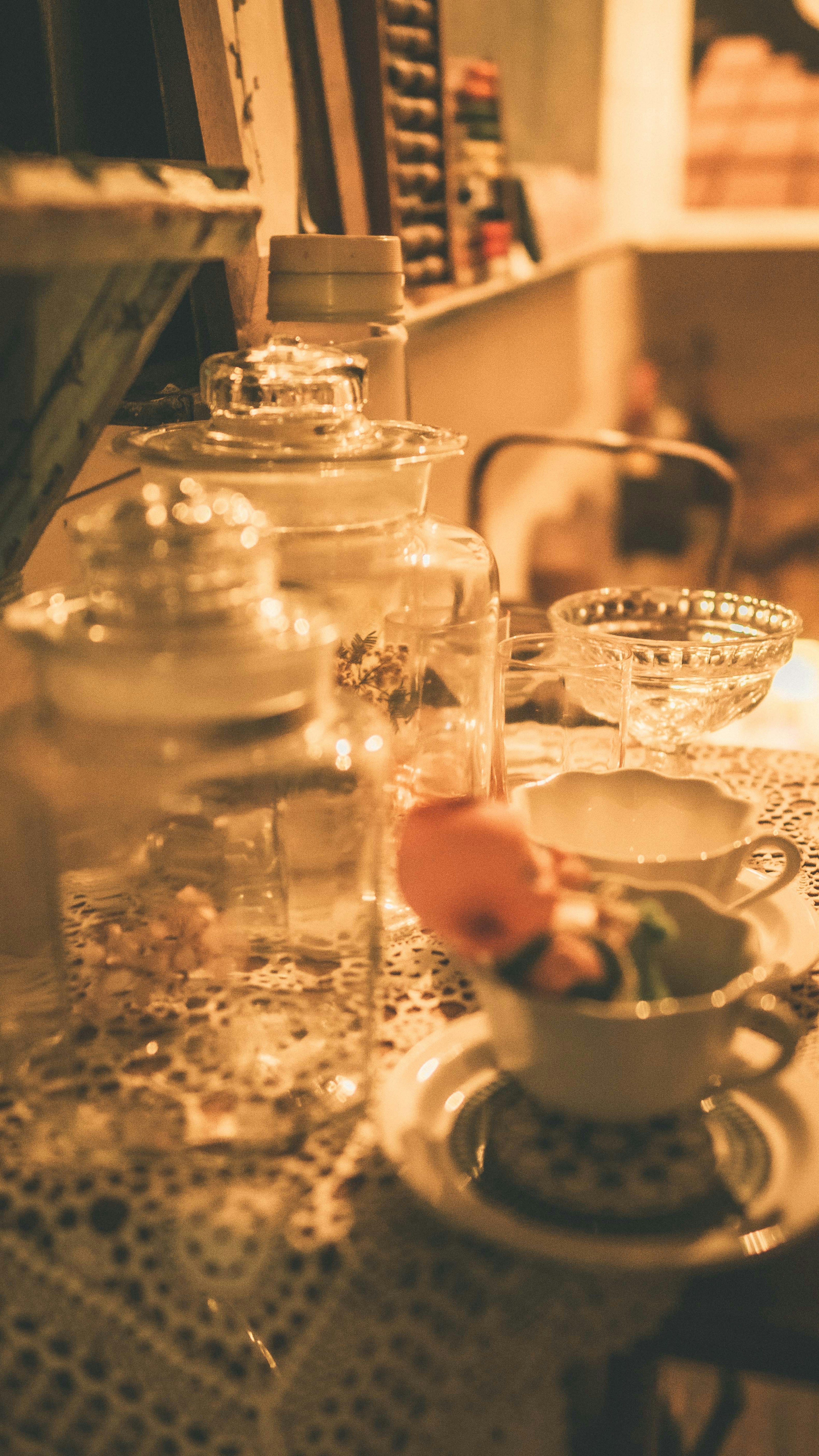 A collection of glass containers and dishware arranged warmly