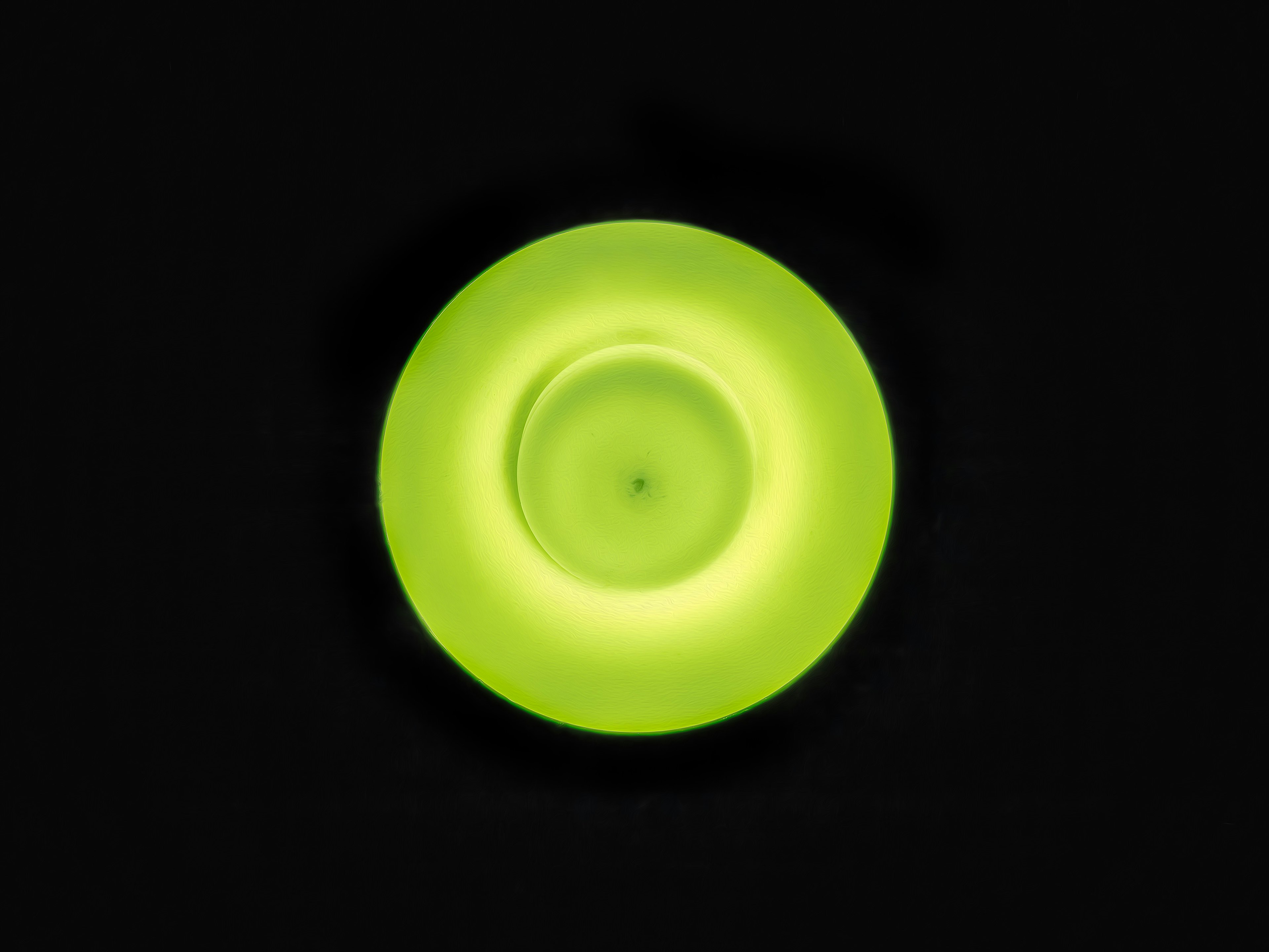 Bright green circular object against a black background