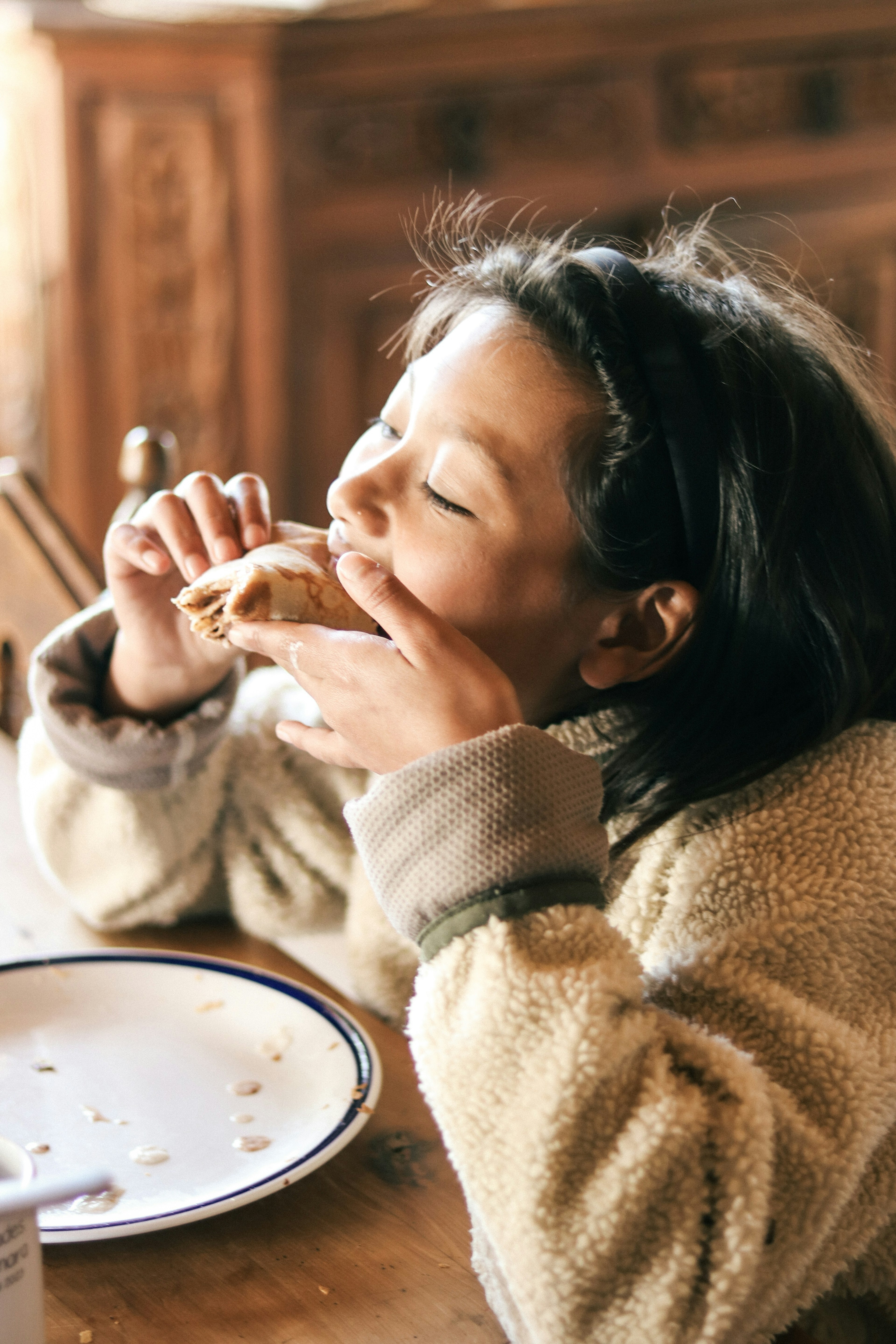 女の子がパンを食べている様子 笑顔で楽しんでいる