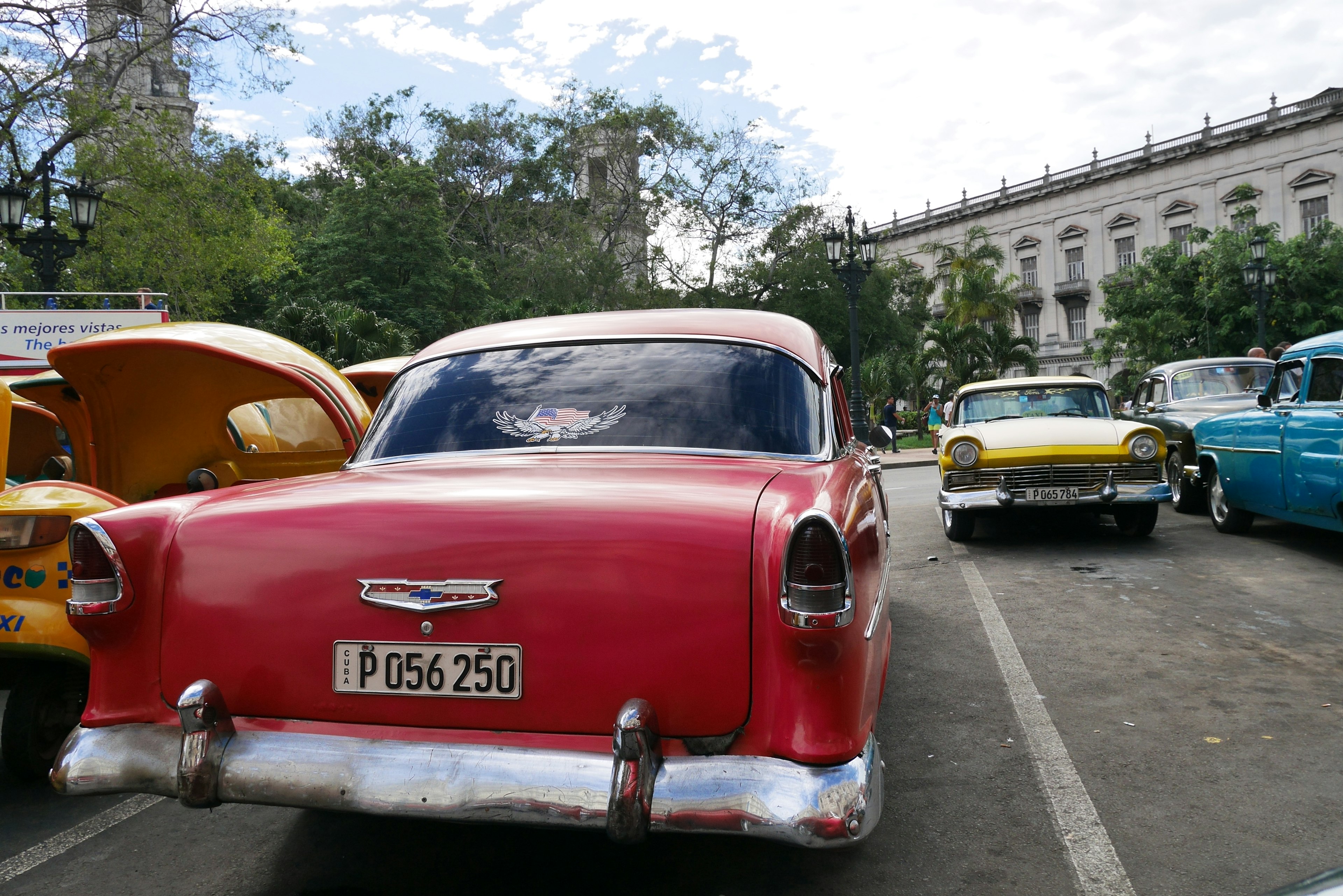 Colorful vintage American cars parked on a street corner