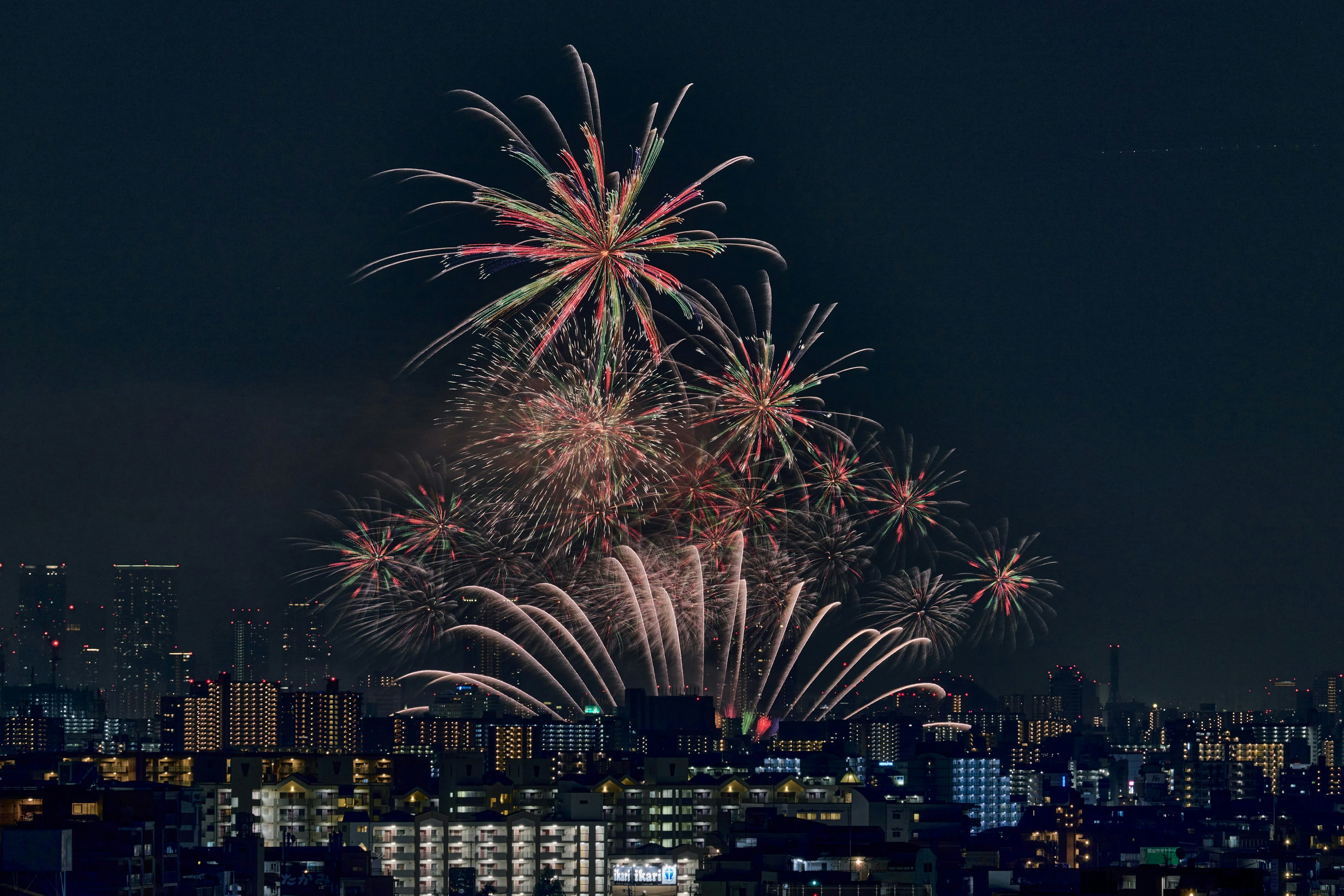 Colorful fireworks bursting in the night sky over a city skyline