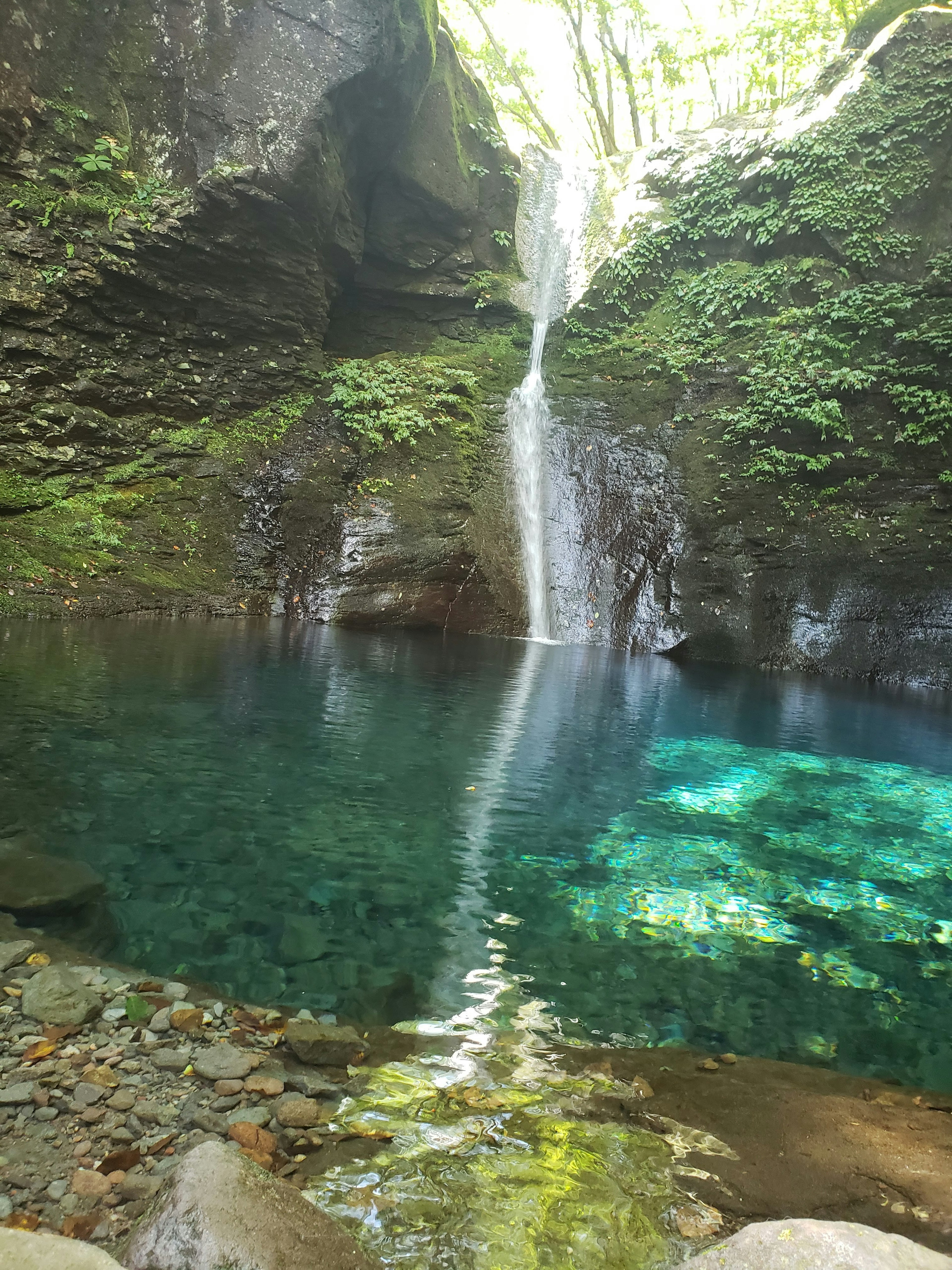 Natural landscape with blue water and a waterfall