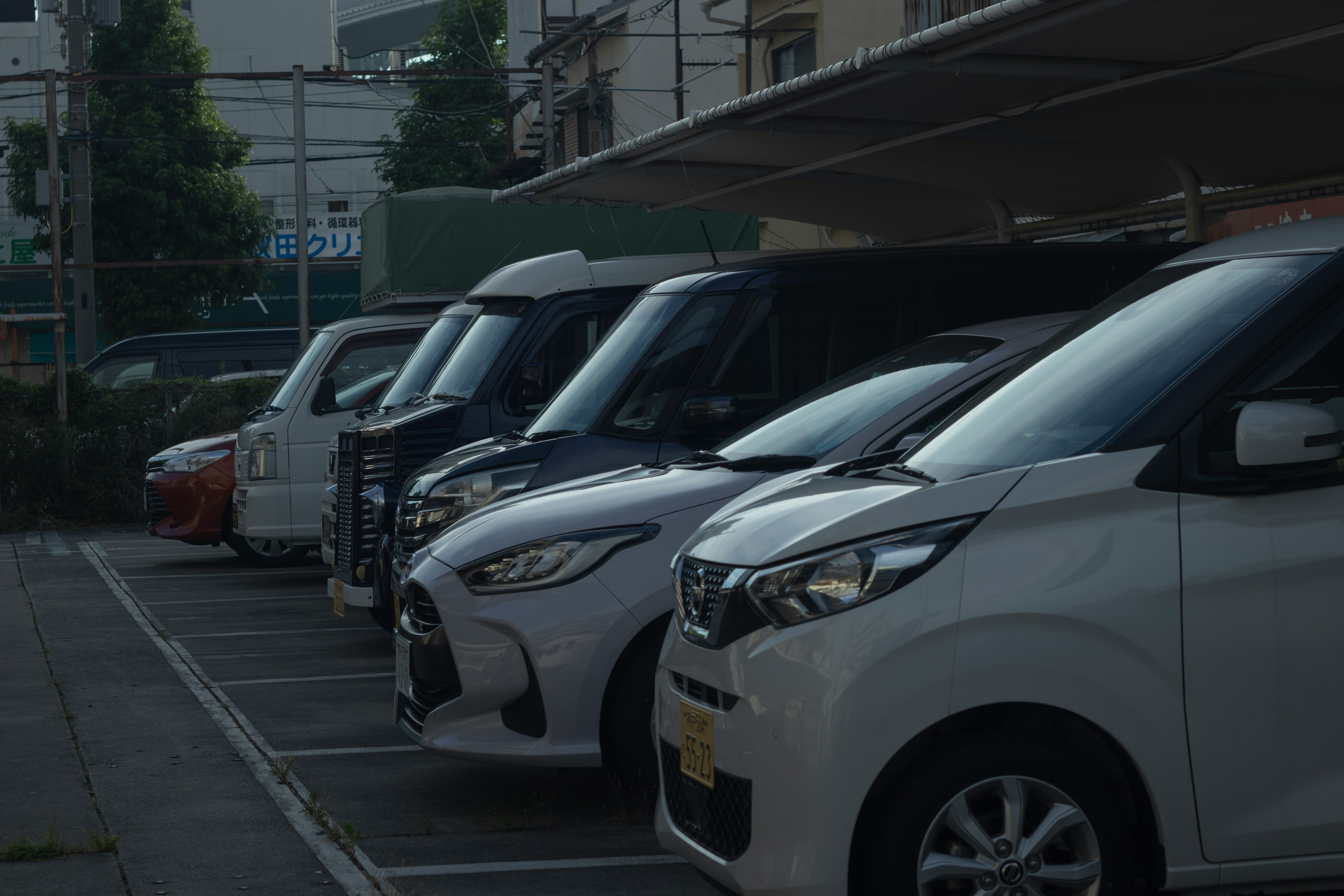 Row of various vehicles parked in a parking lot