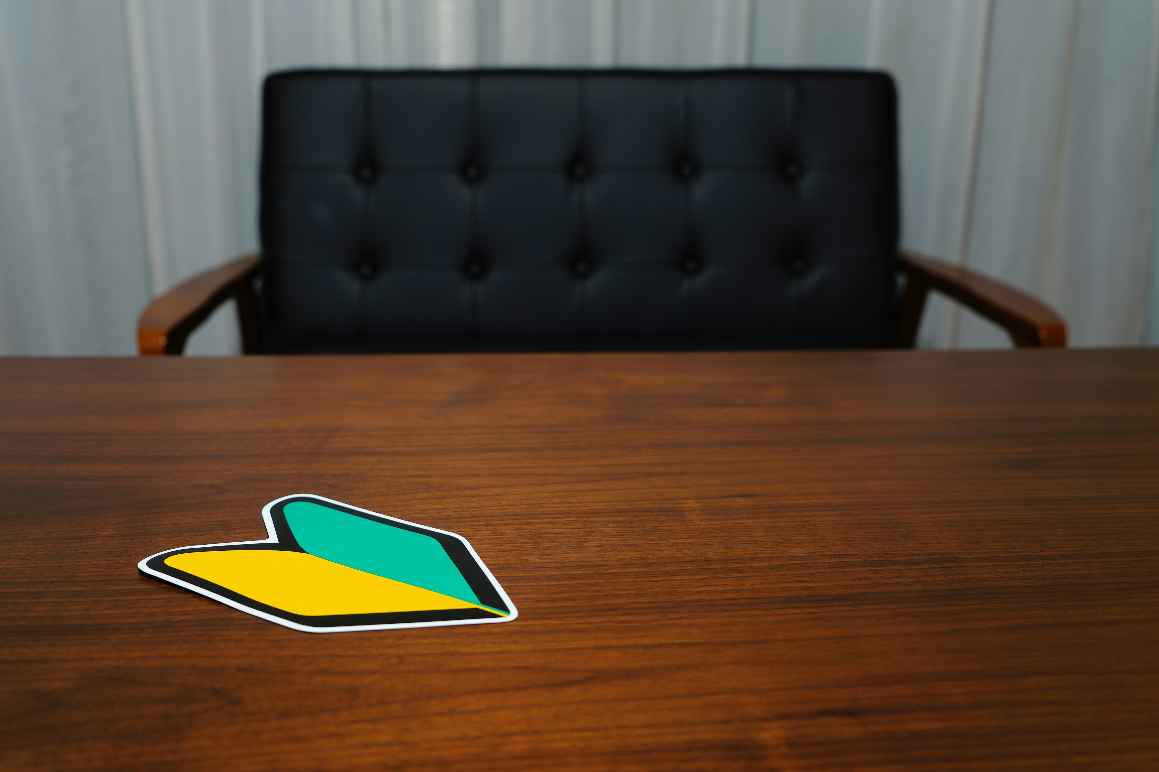 Colorful sticker on a wooden table with a black sofa in the background