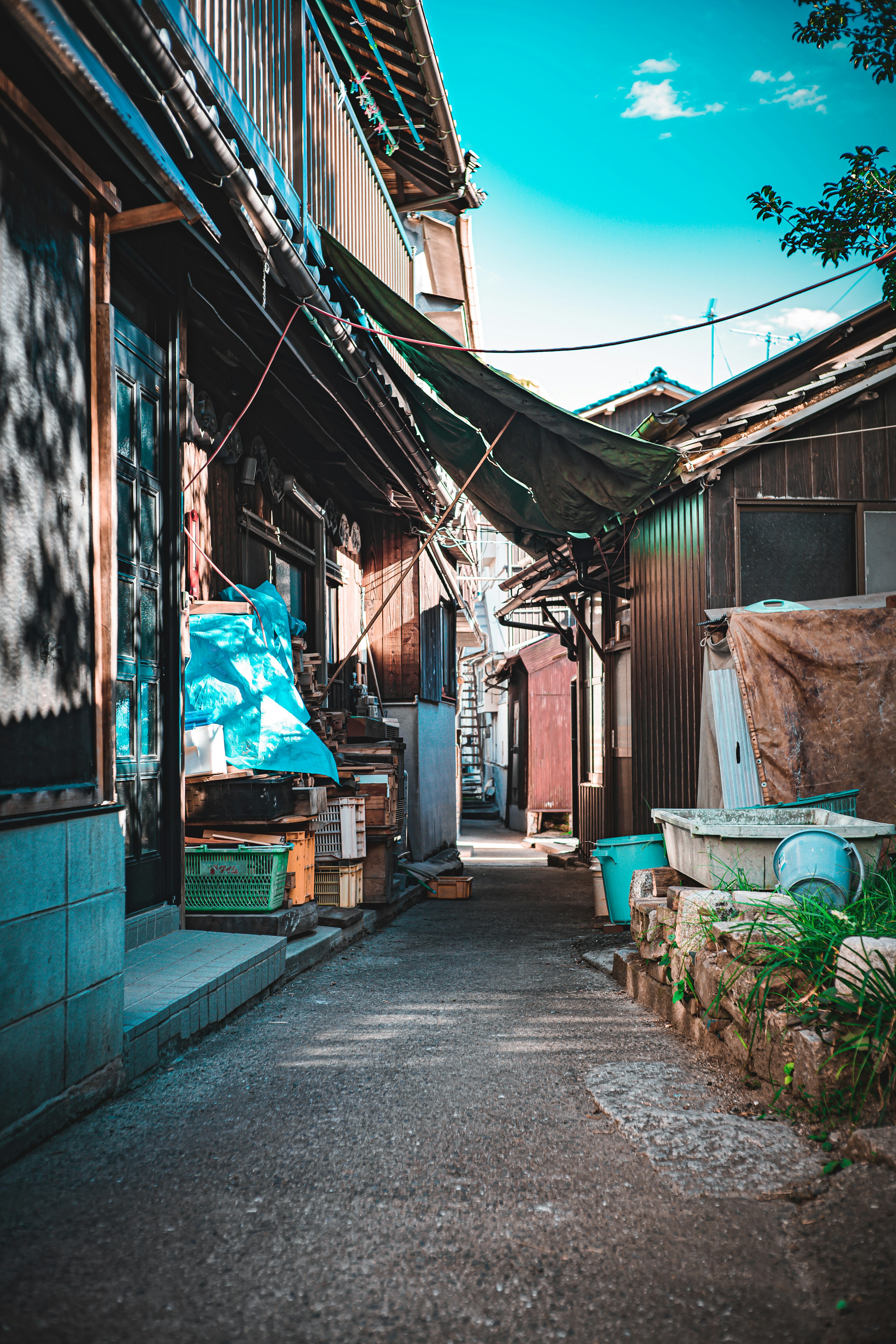 狭い路地に沿った古い家々と青い空の風景