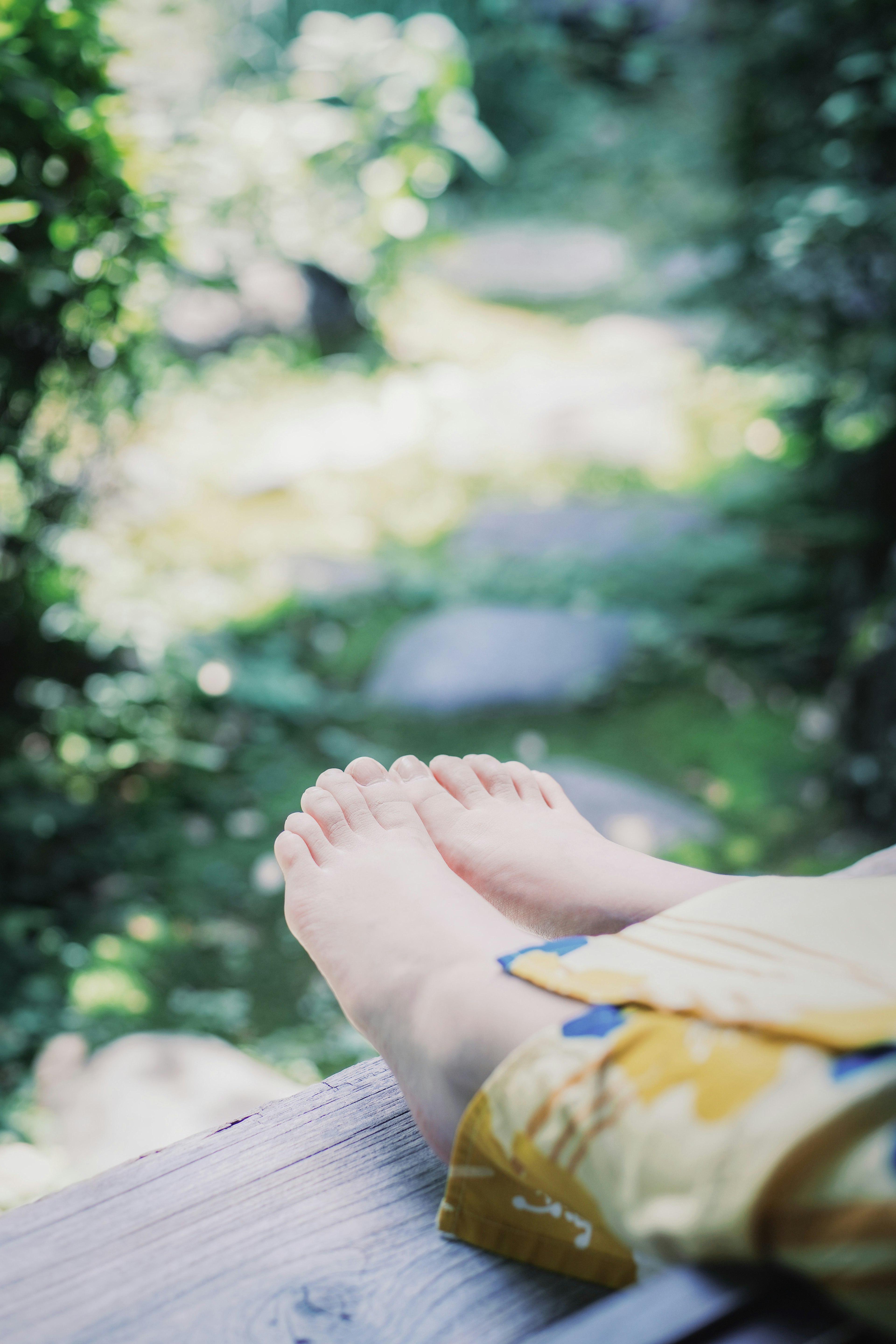 Close-up of bare feet resting in a serene natural setting