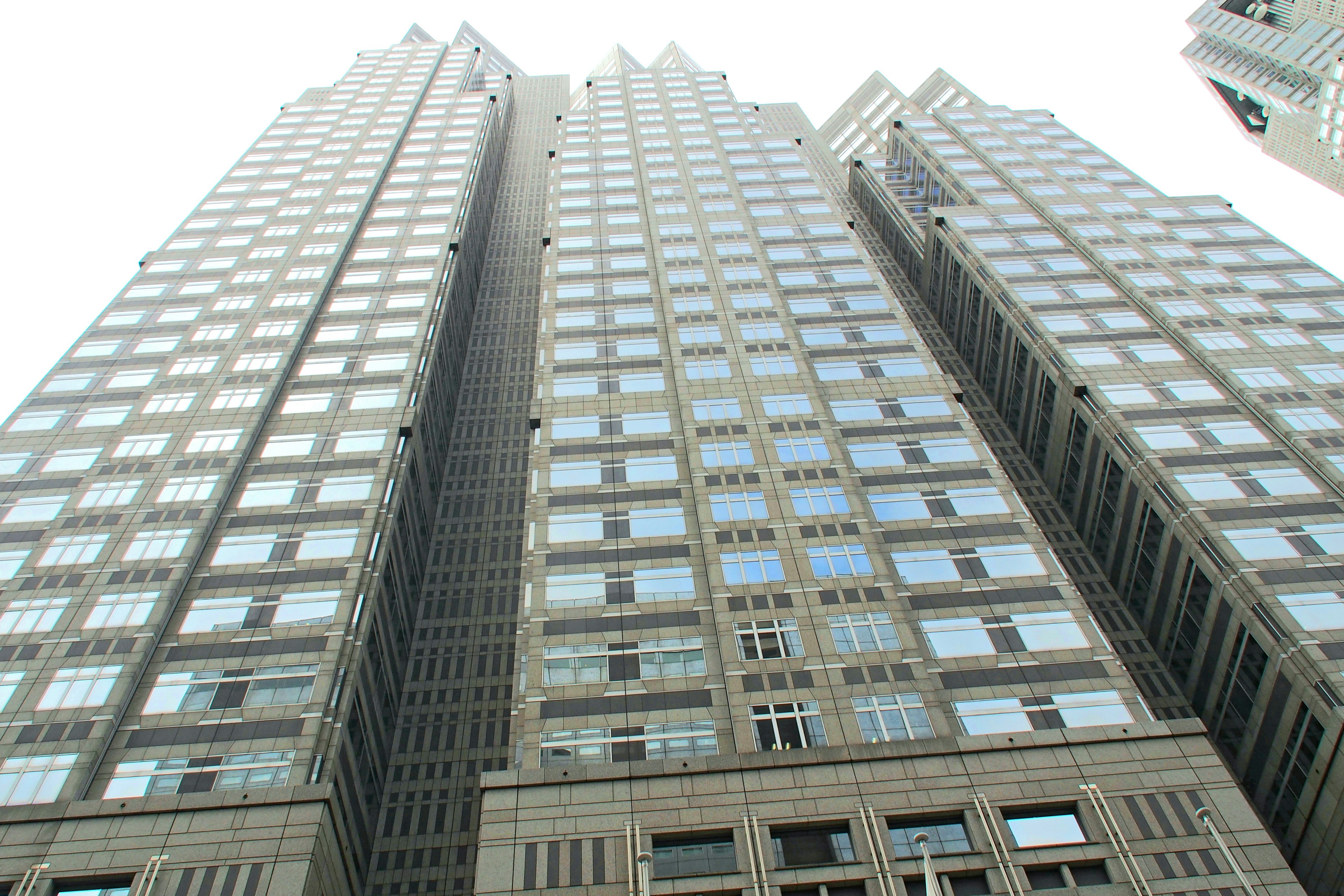 Photo of a skyscraper viewed from below featuring glass windows and modern architecture