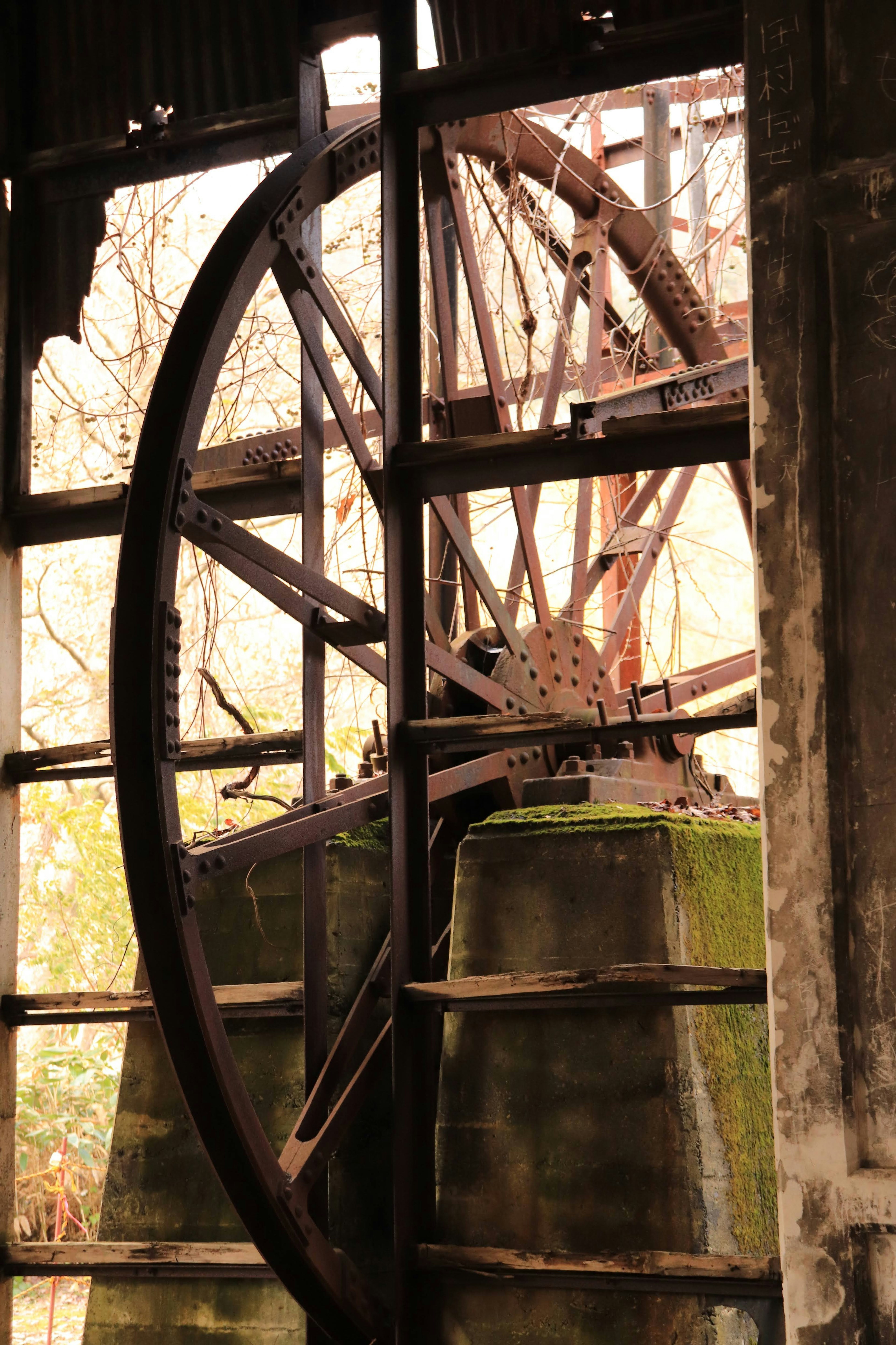 Interior view of an old waterwheel with sunlight filtering through