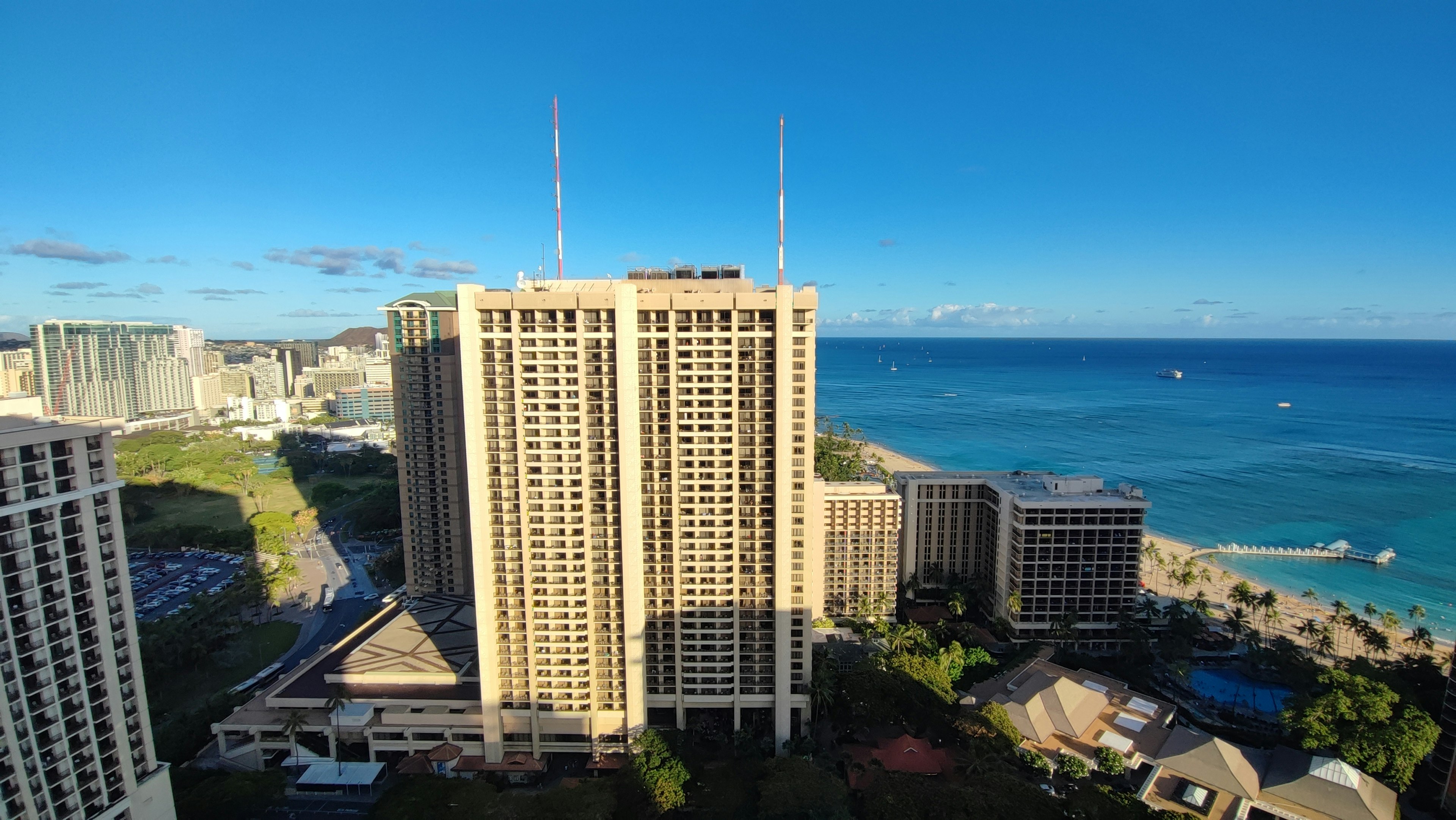 View of high-rise buildings with blue ocean and sky