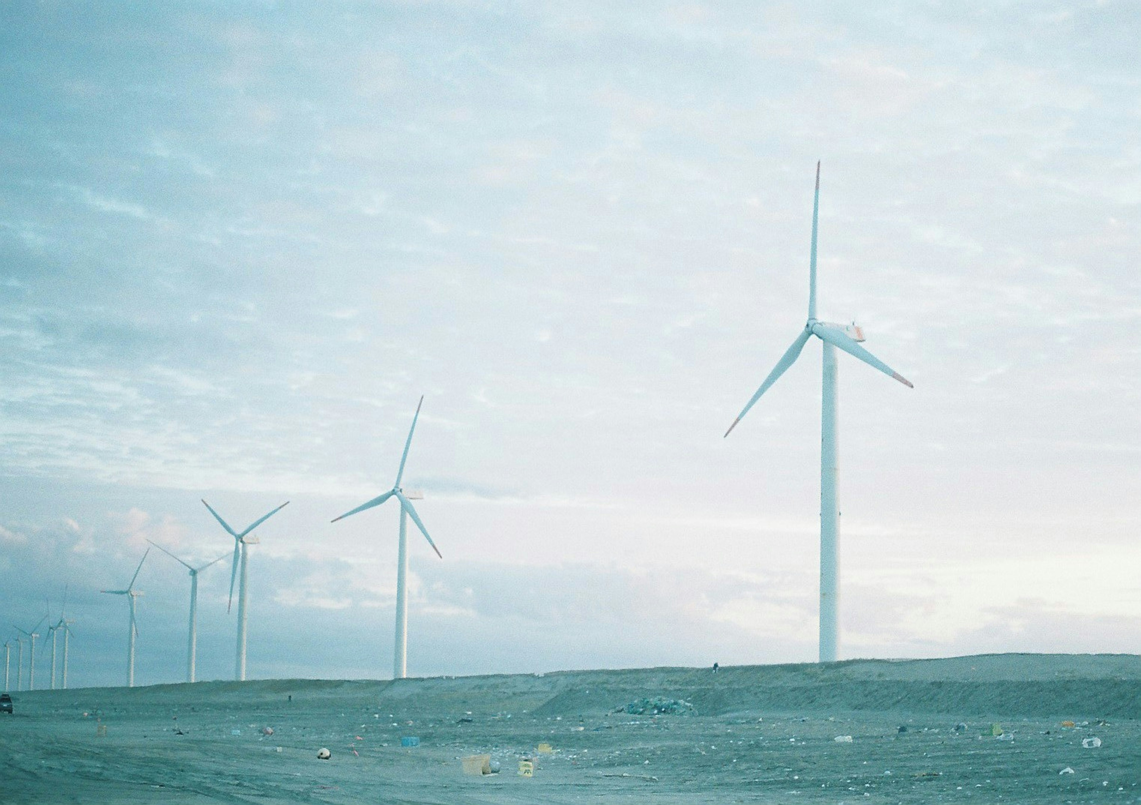 Landscape featuring wind turbines against a serene blue sky