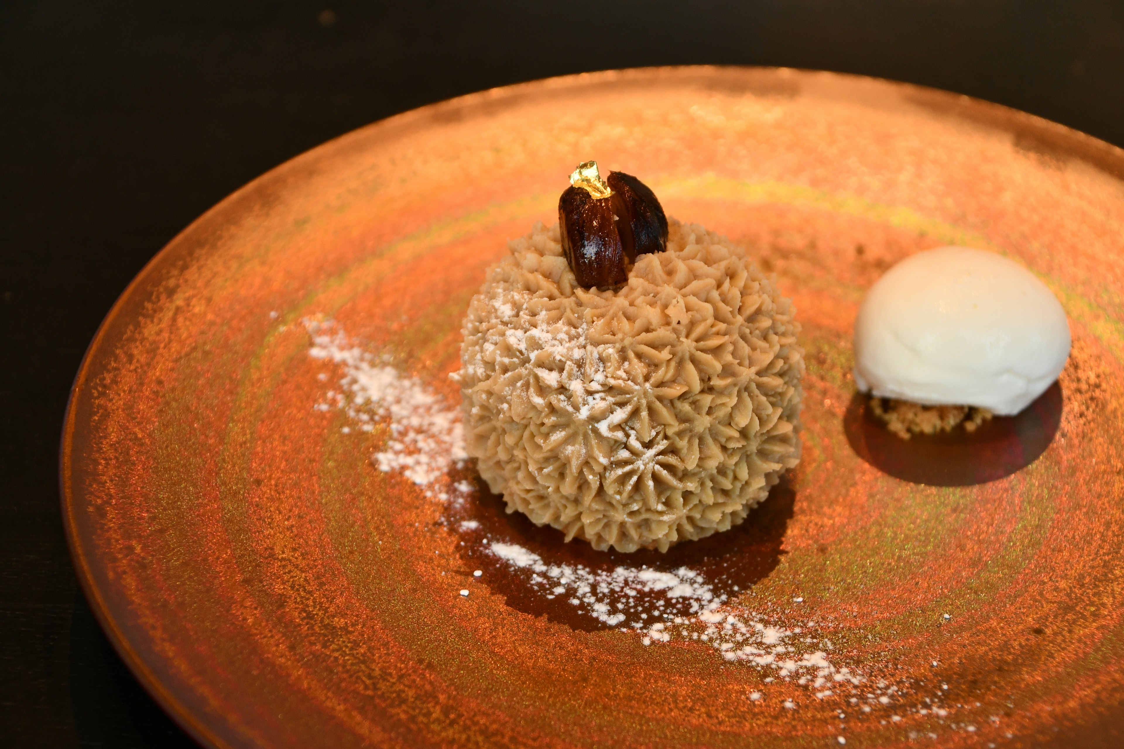 A beautifully plated dessert featuring a creamy dessert and ice cream