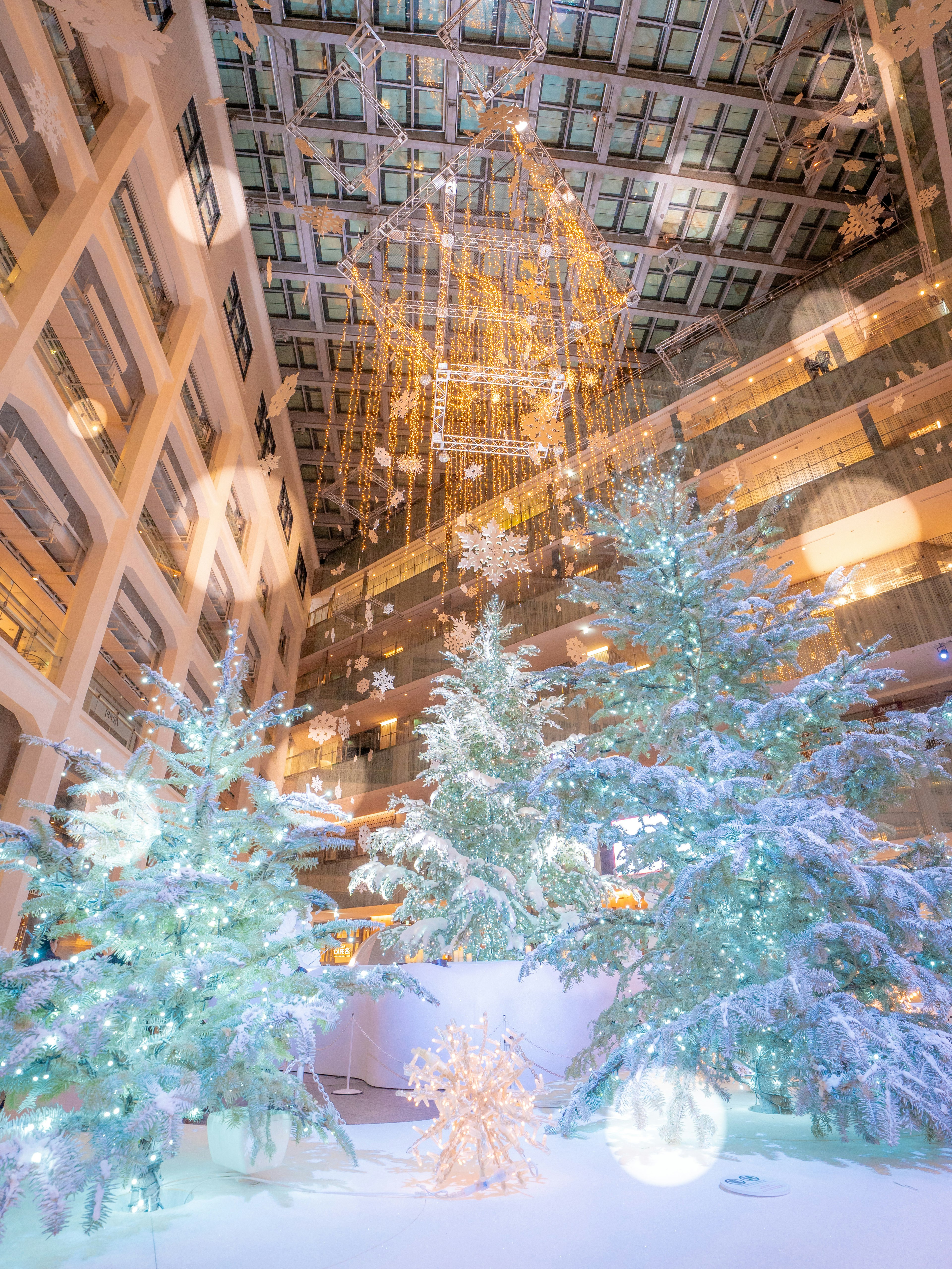 Christmas decorated lobby with snowy trees and glowing ornaments