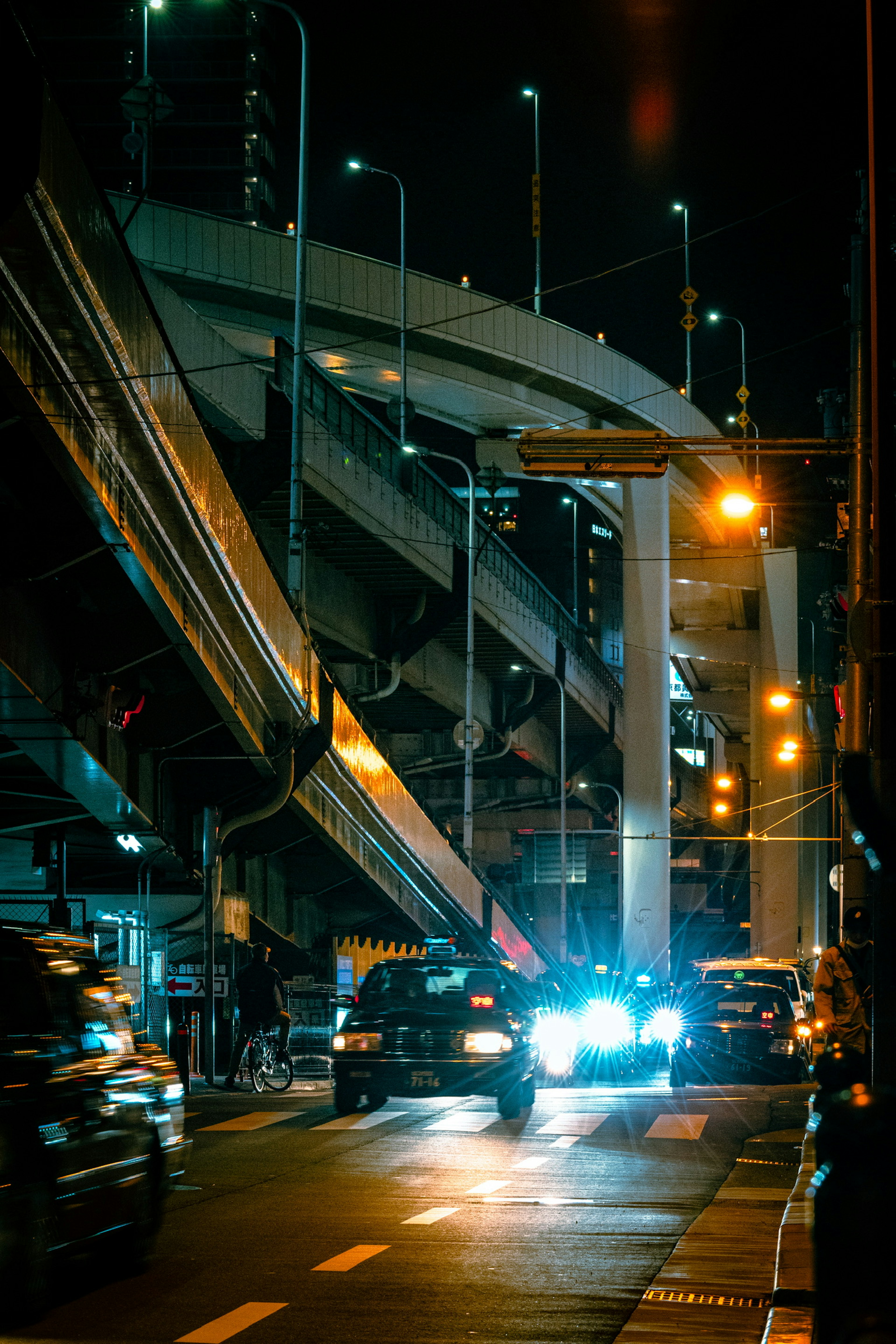 Complex urban scene at night featuring roads and traffic flow