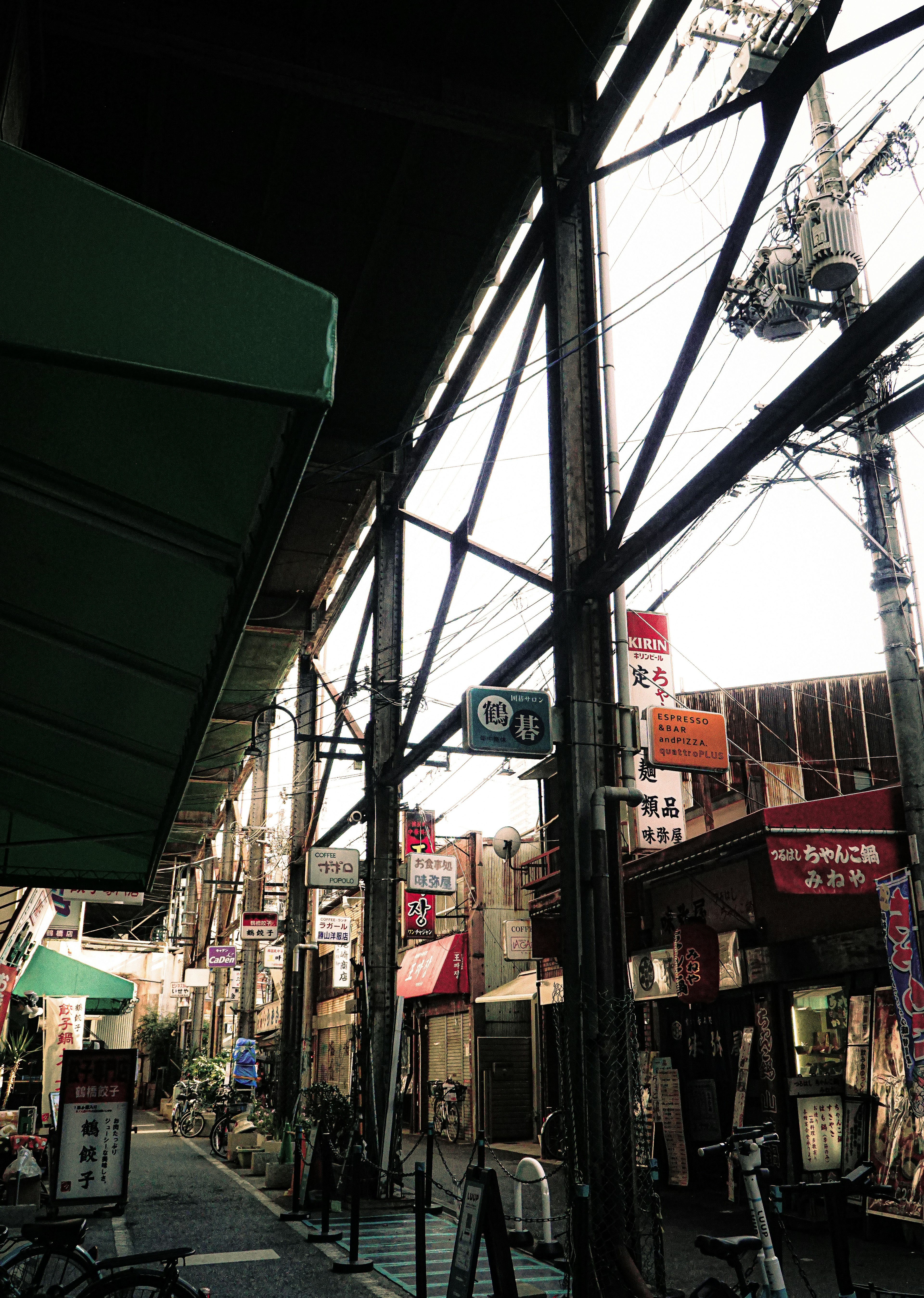 View of a shopping street with a steel structure arcade