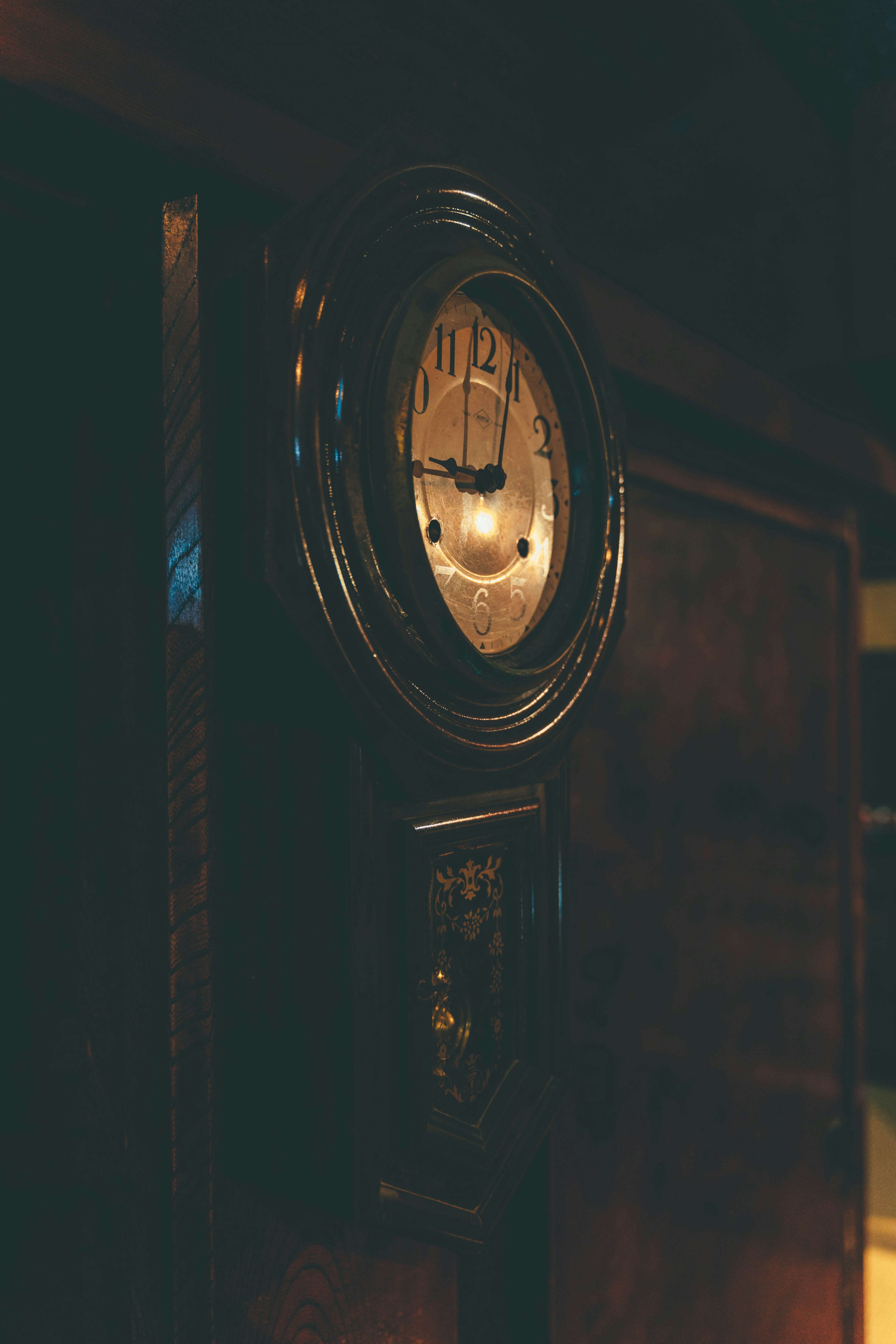 Close-up of an antique clock against a dark background