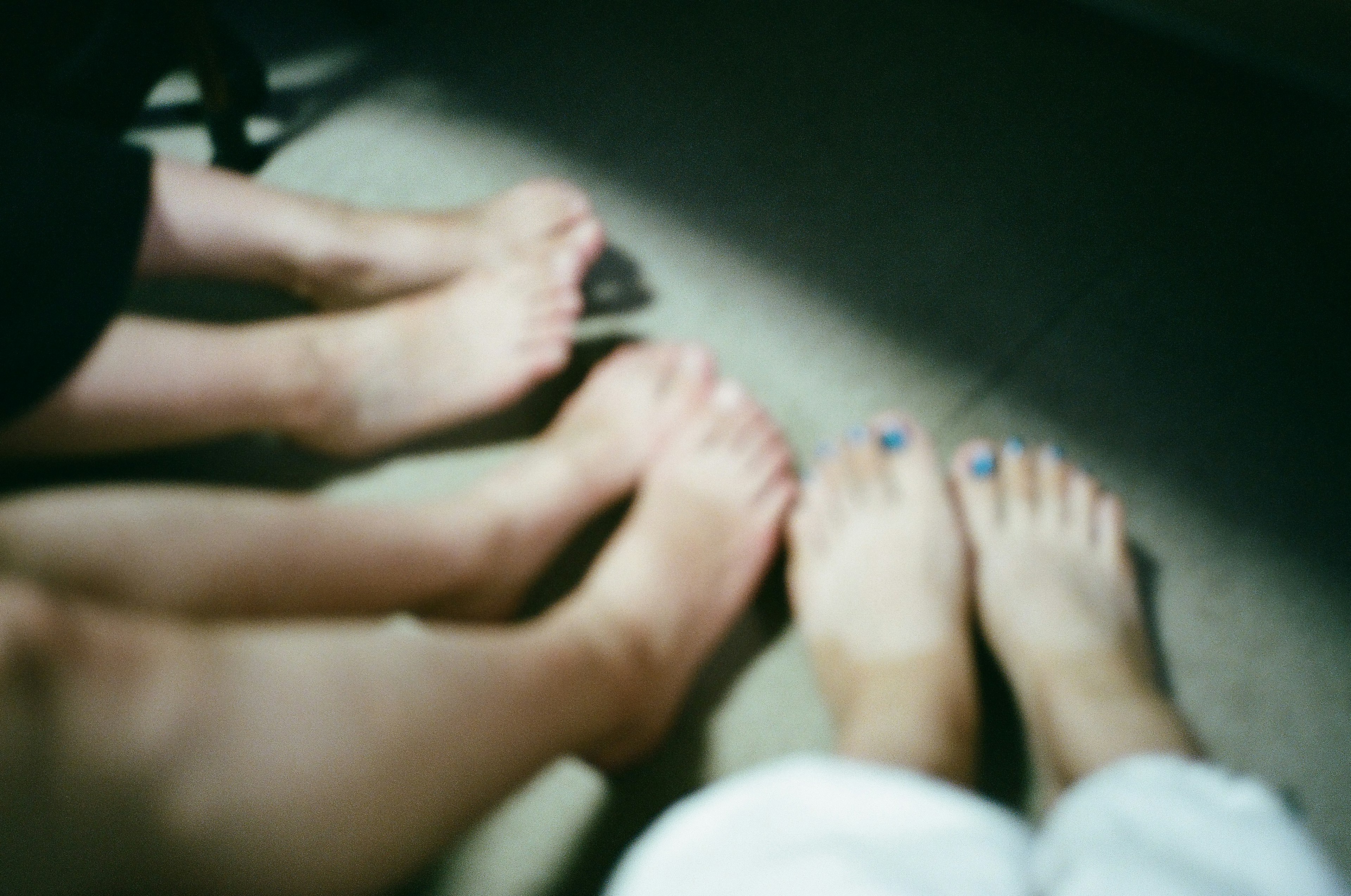 Casual scene showing feet of different skin tones positioned together