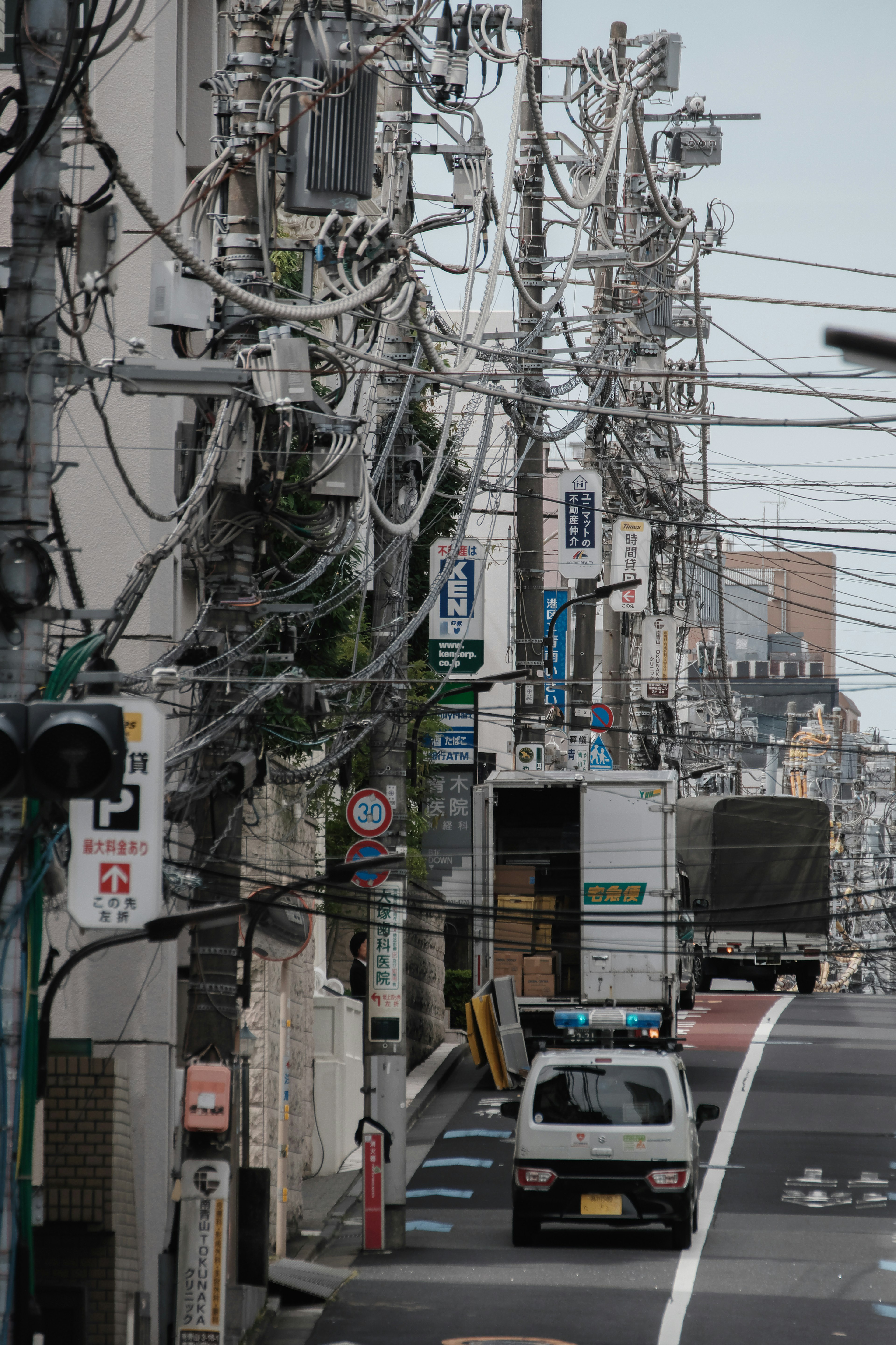 Urban scene with tangled power lines and a parked truck