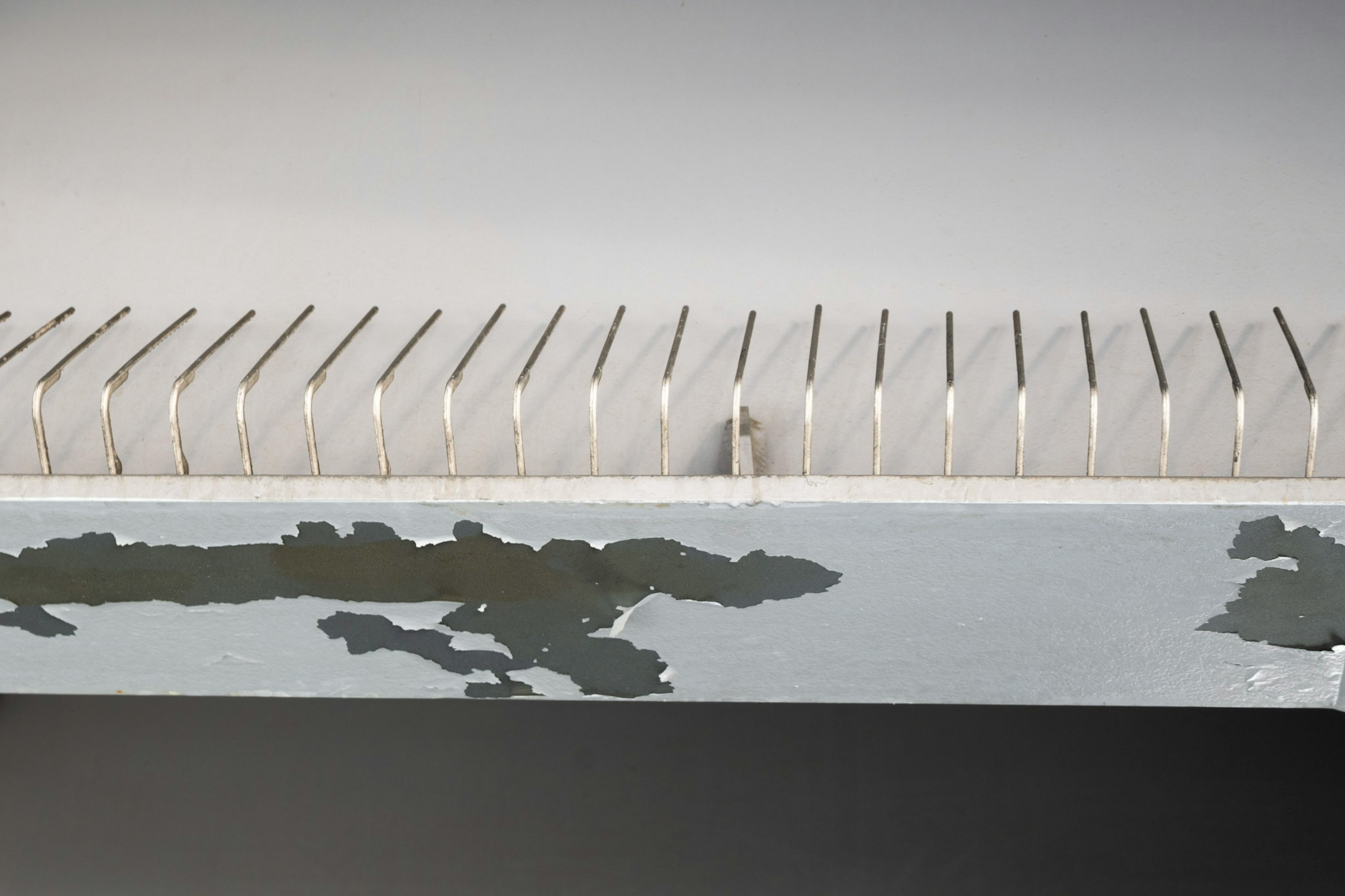 A simple design object featuring a row of book spines on a white surface