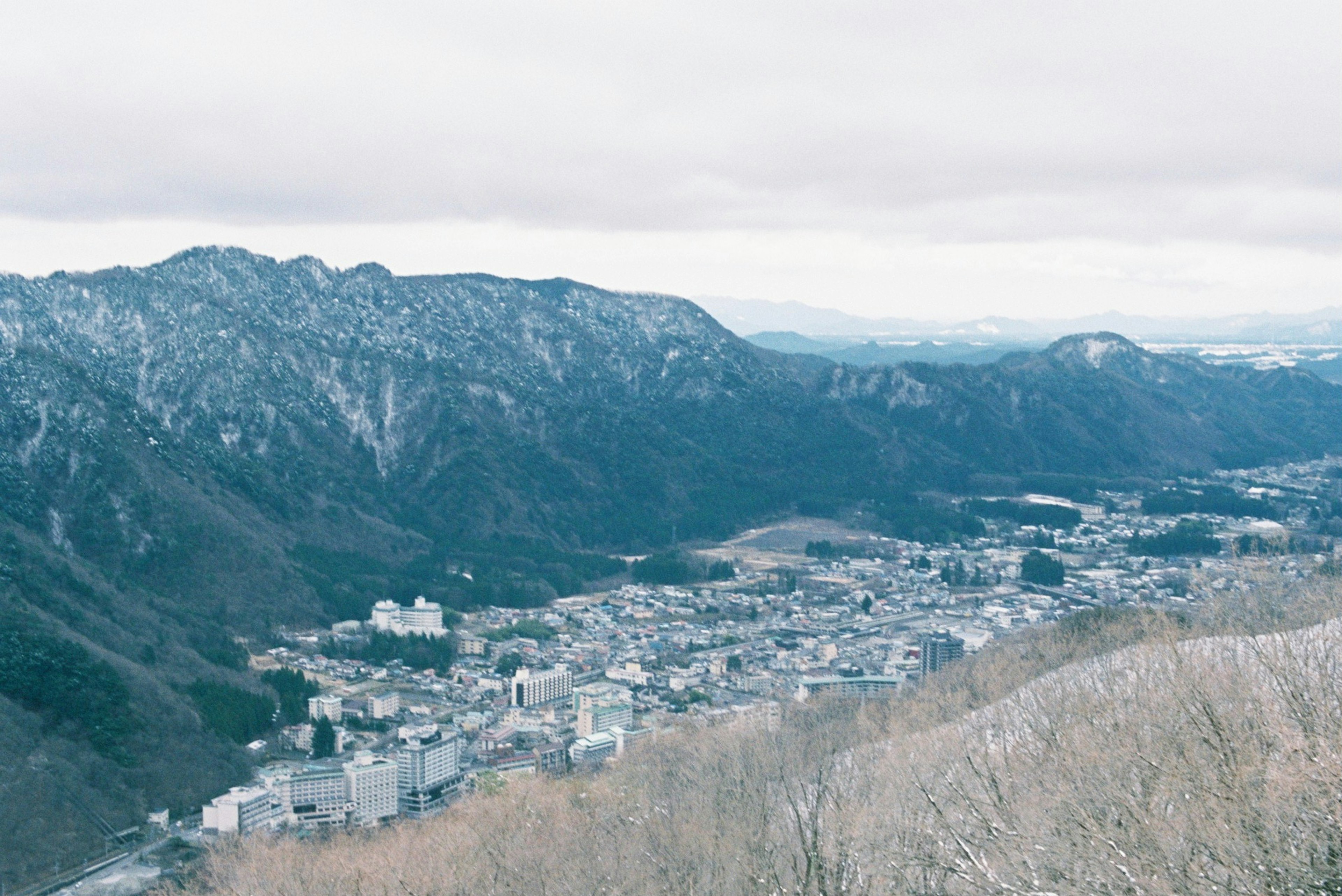 Scenic view of mountains and a town below