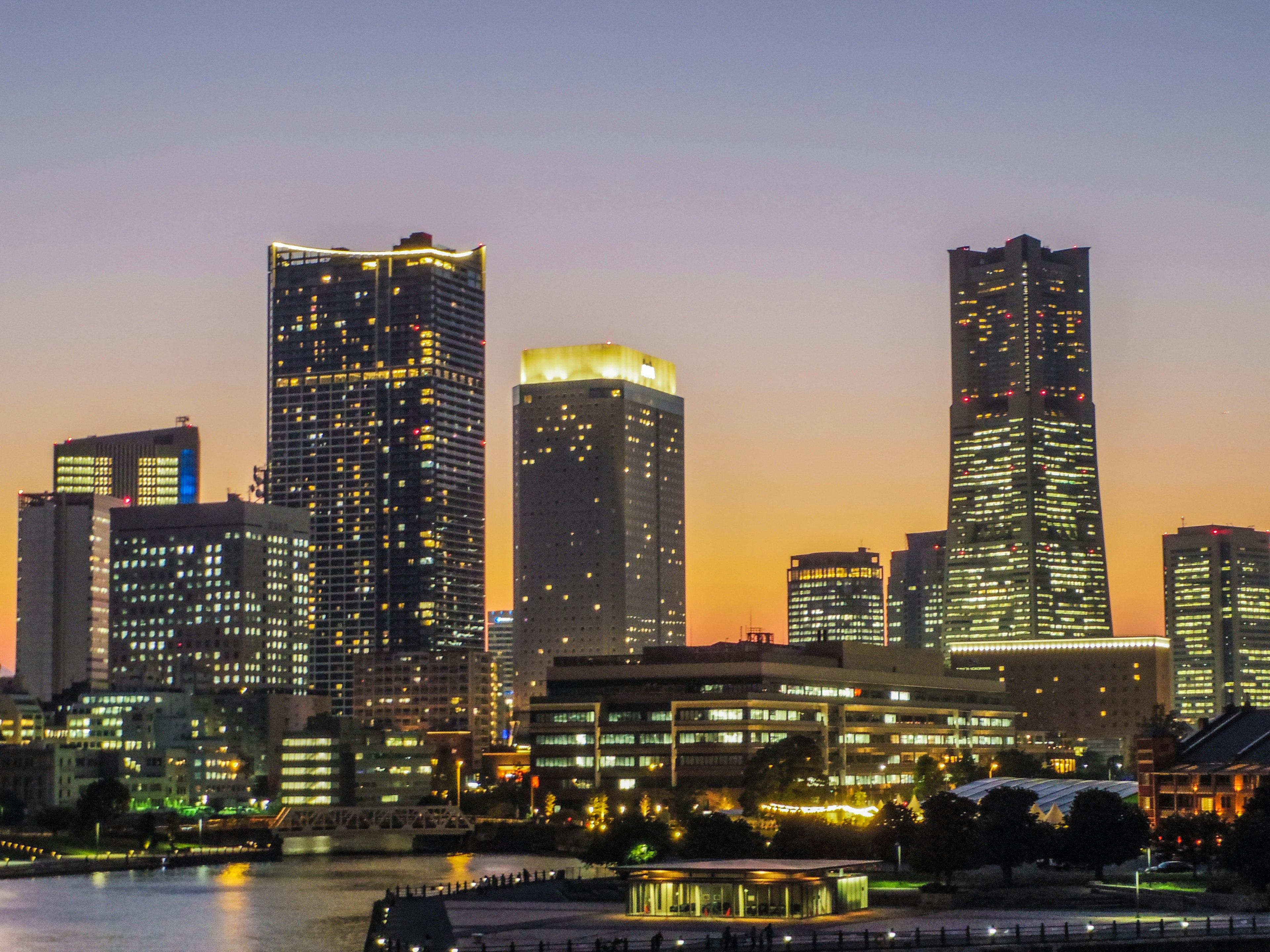 Yokohama skyline with skyscrapers illuminated by sunset