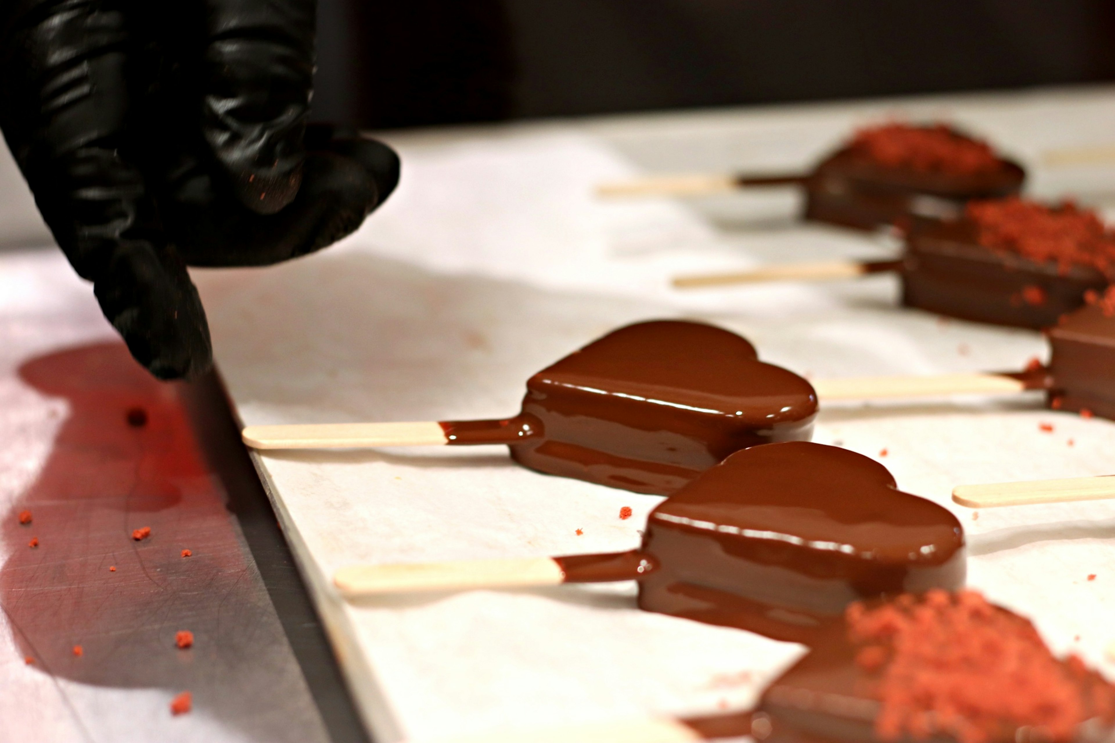 Paletas de chocolate en forma de corazón dispuestas sobre una superficie