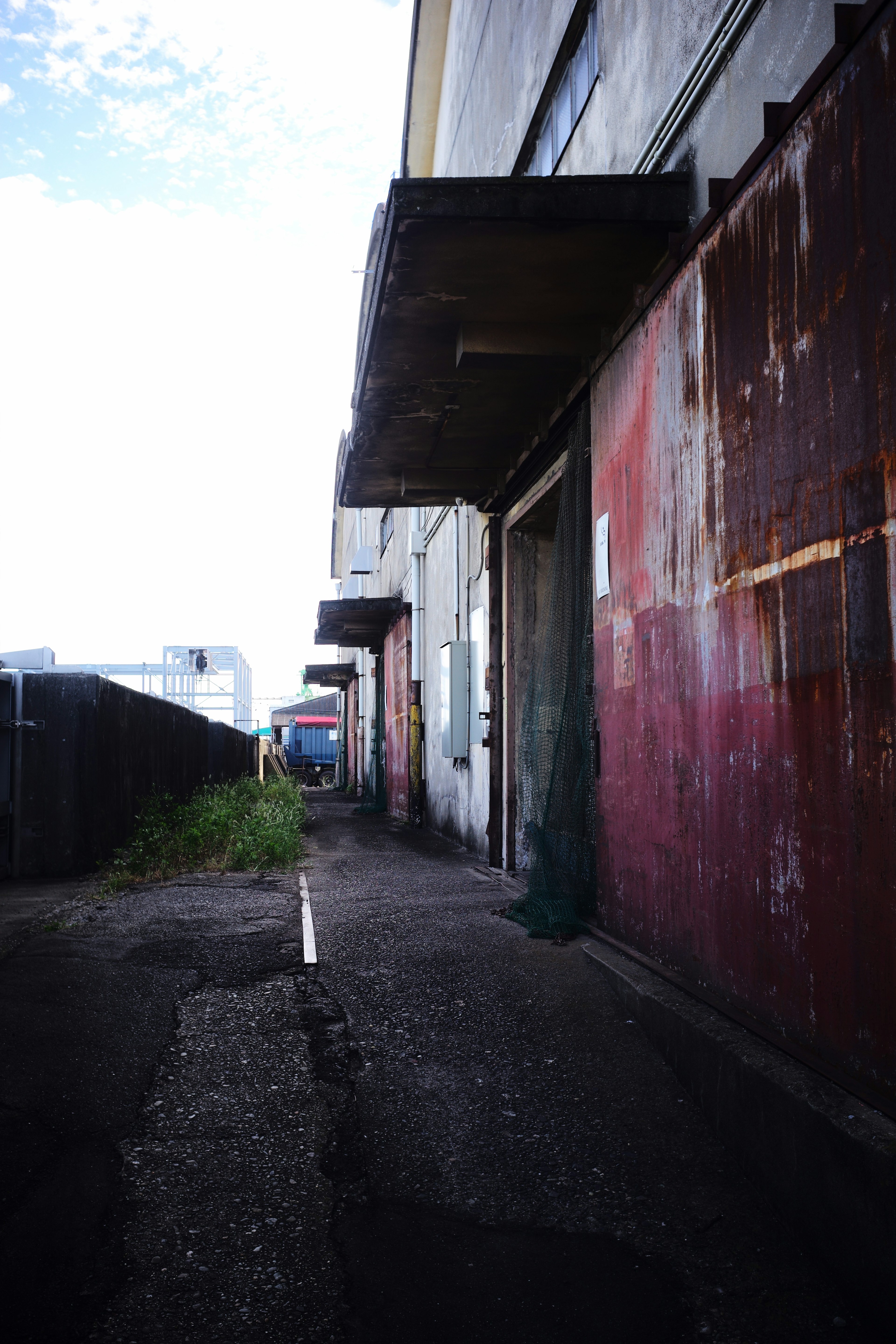 Exterior of an old warehouse with a weathered pathway