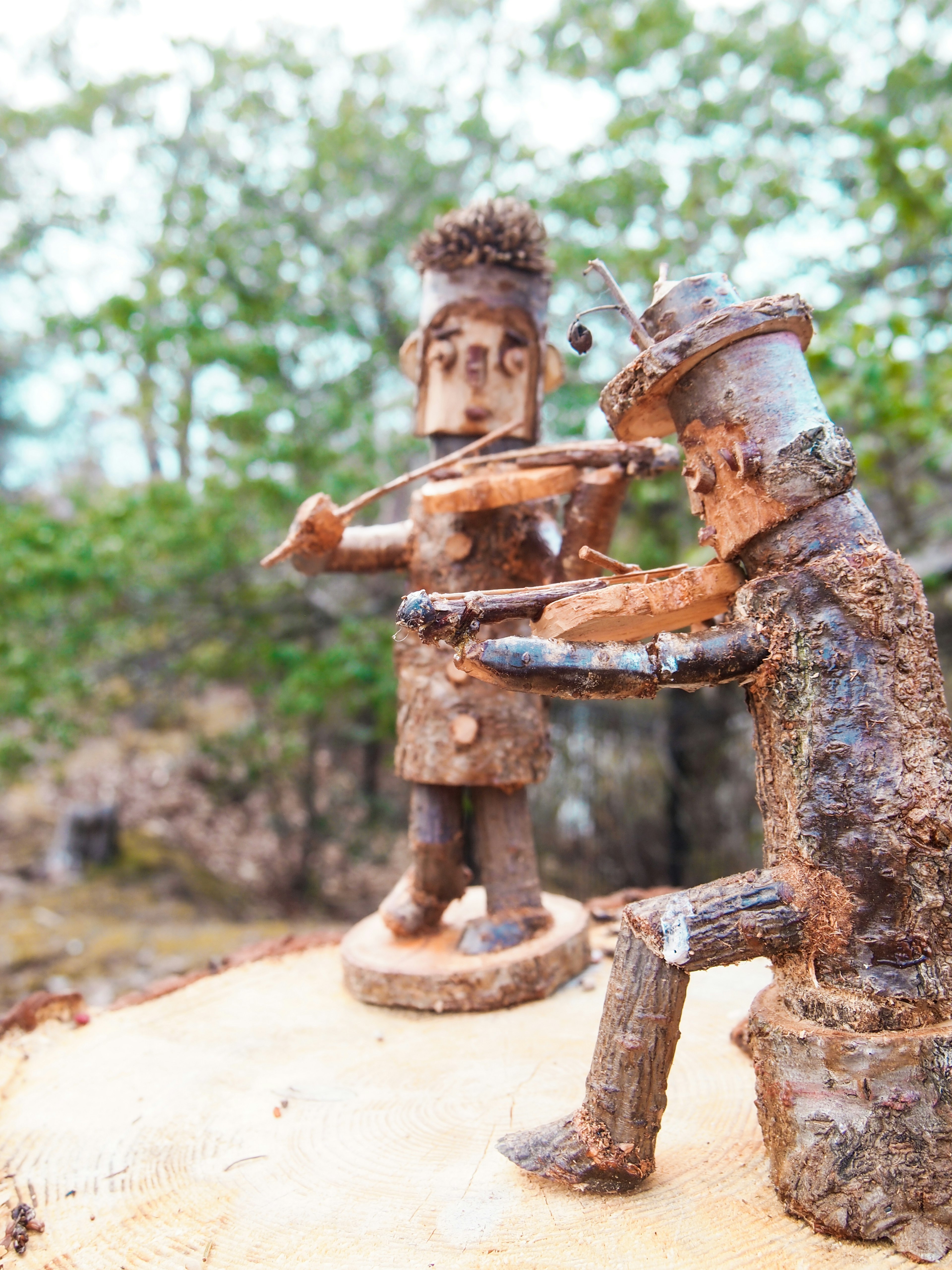 Wooden sculptures of figures playing musical instruments