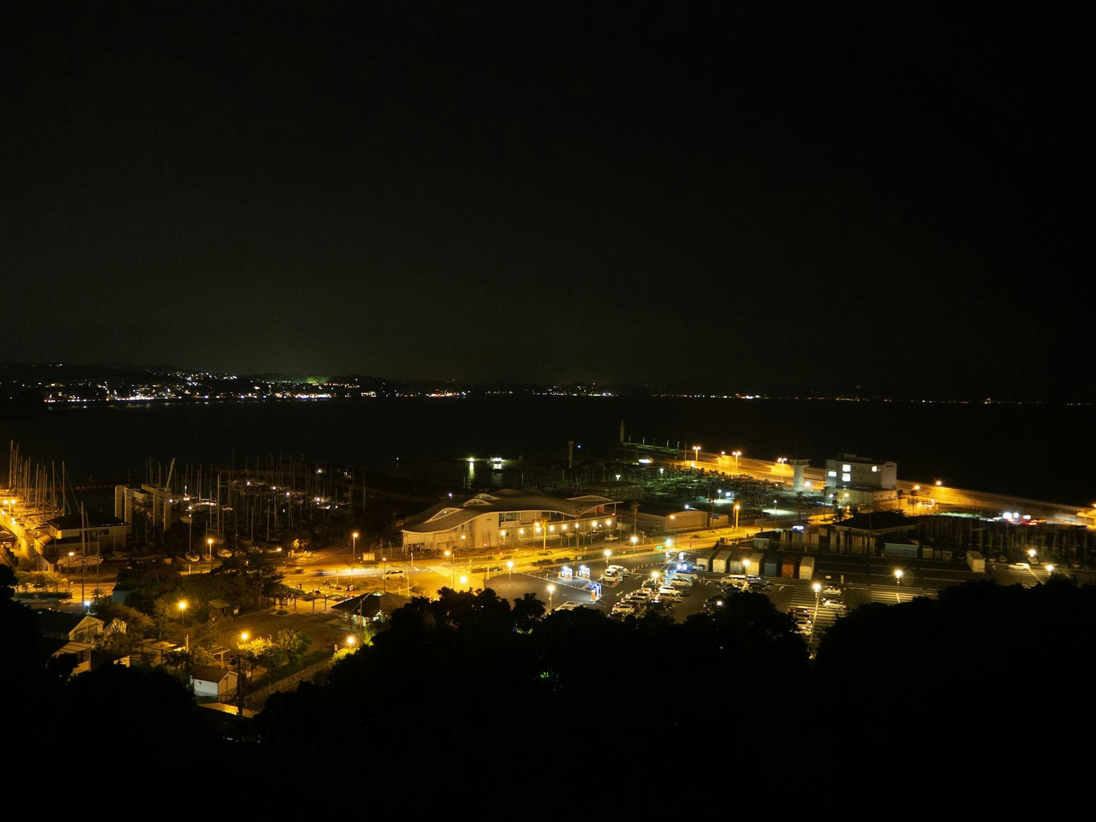 Night view of a harbor with shimmering lights