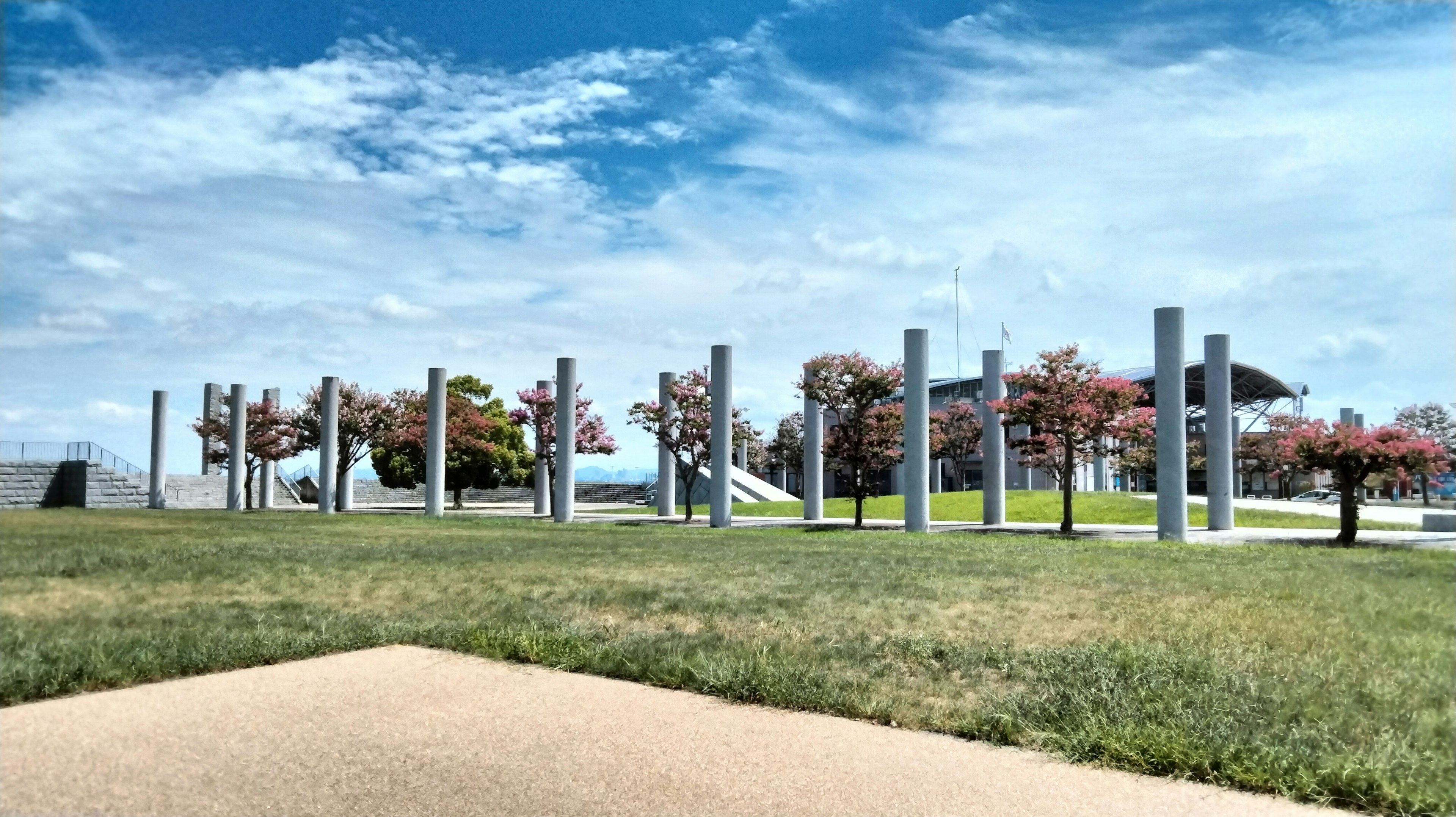 Park view featuring standing pillars and cherry blossom trees