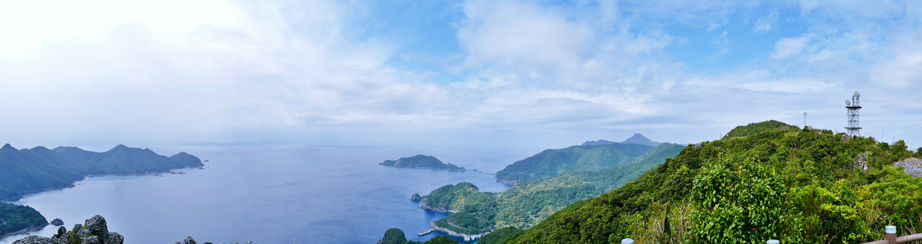 Panoramic view of lush green mountains and vast ocean