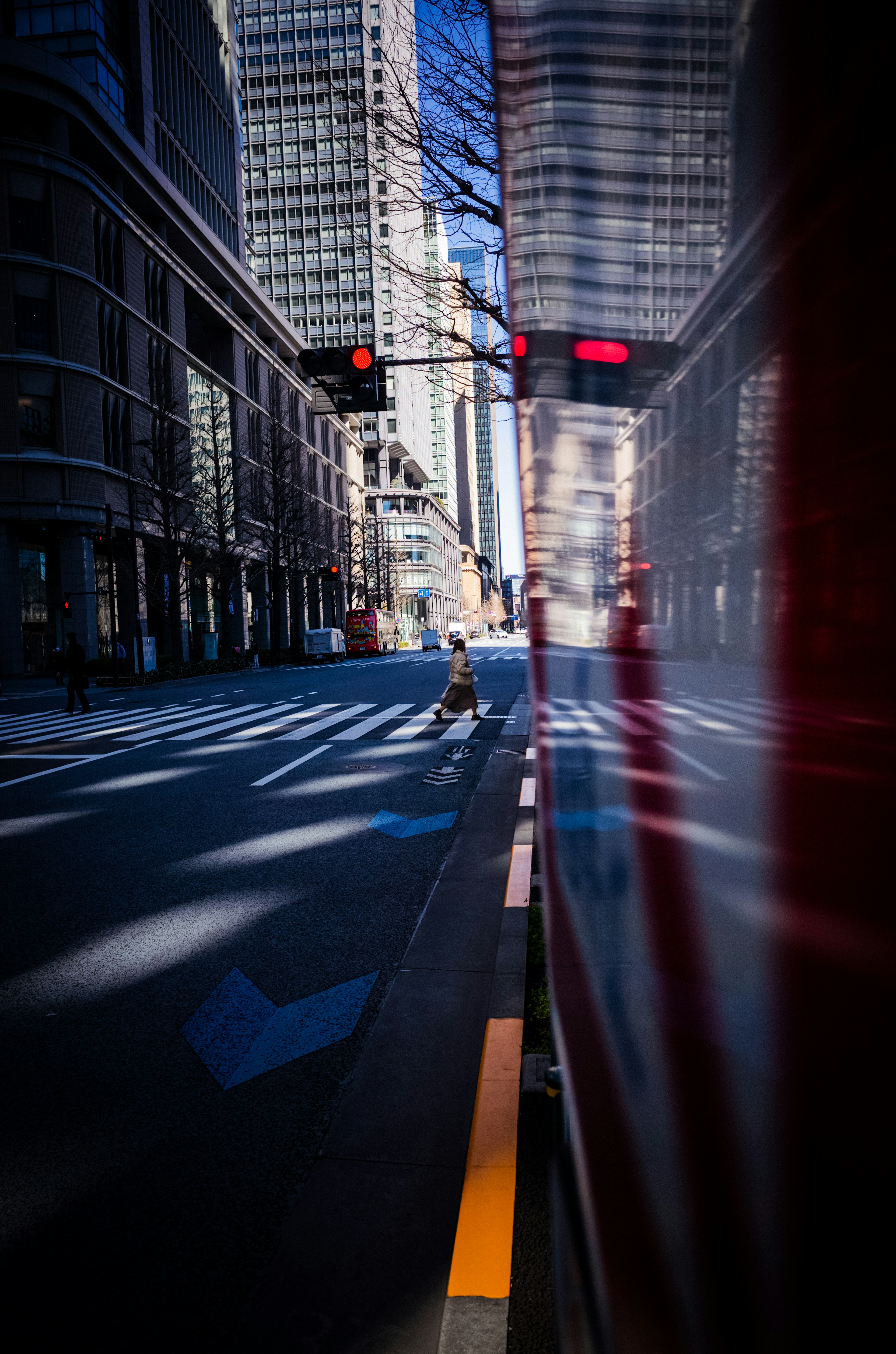 Urban street scene with traffic lights and reflections