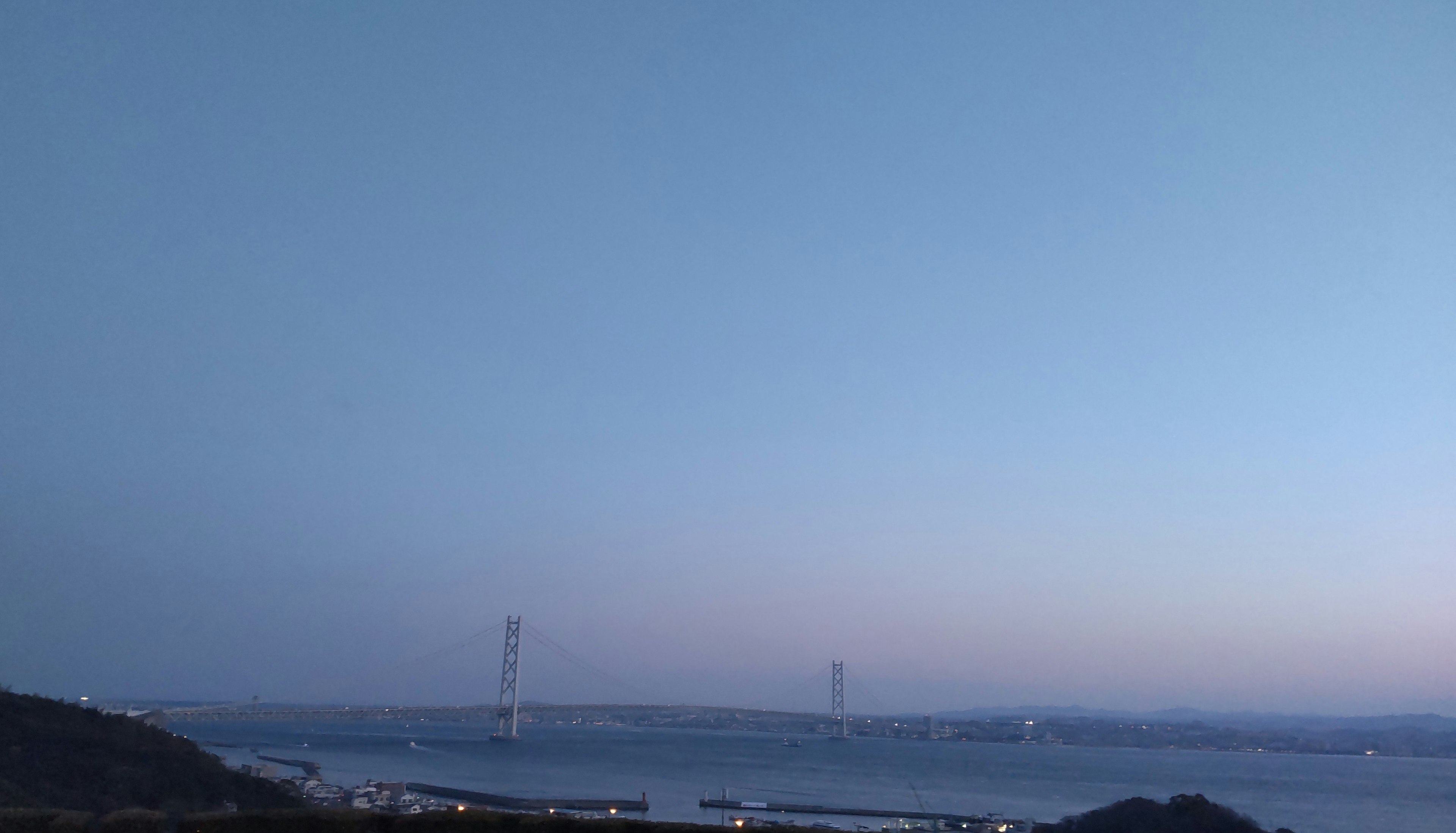 Silhouette d'un pont sur la mer au crépuscule