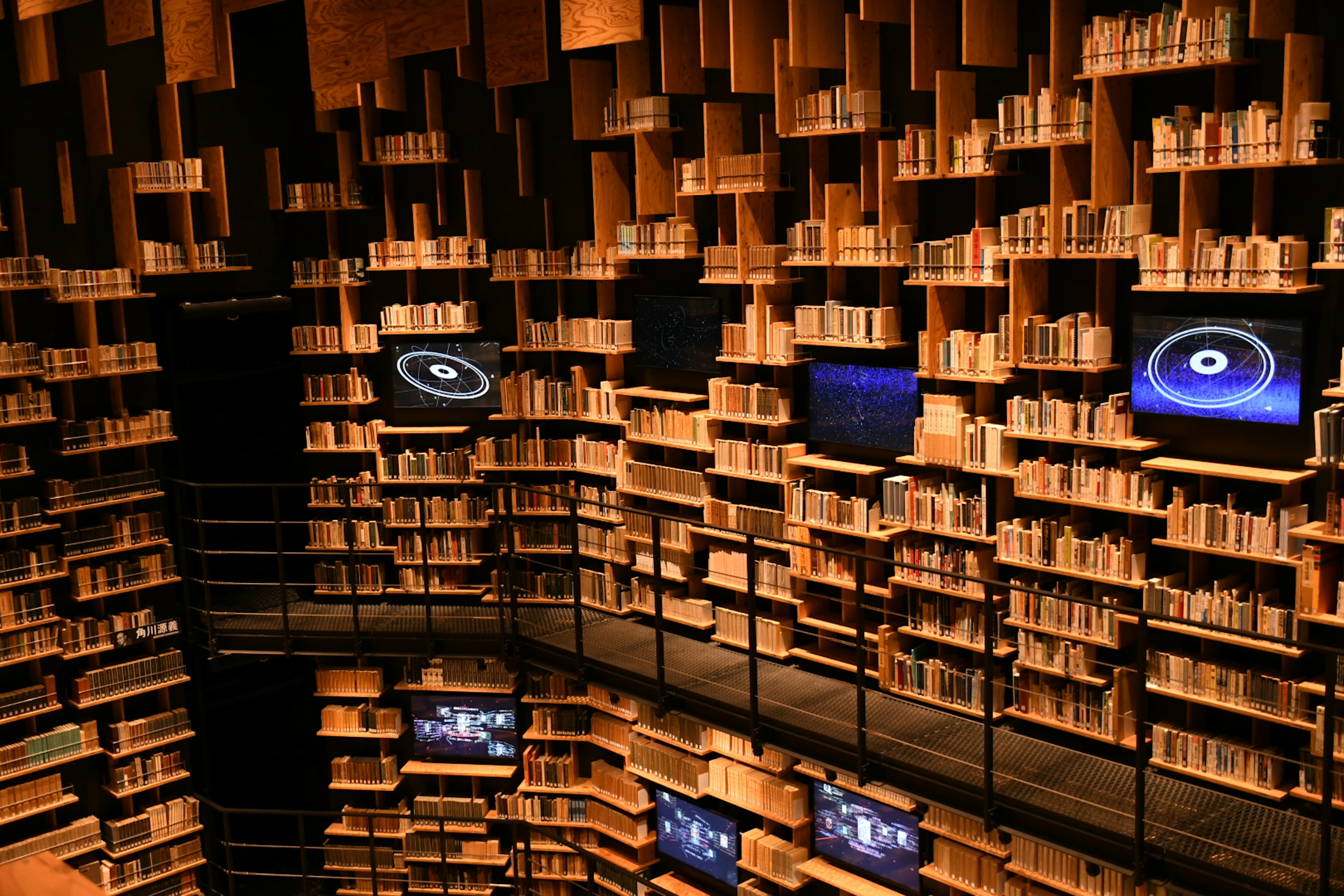 Unique design of library interior with shelves of books and monitors