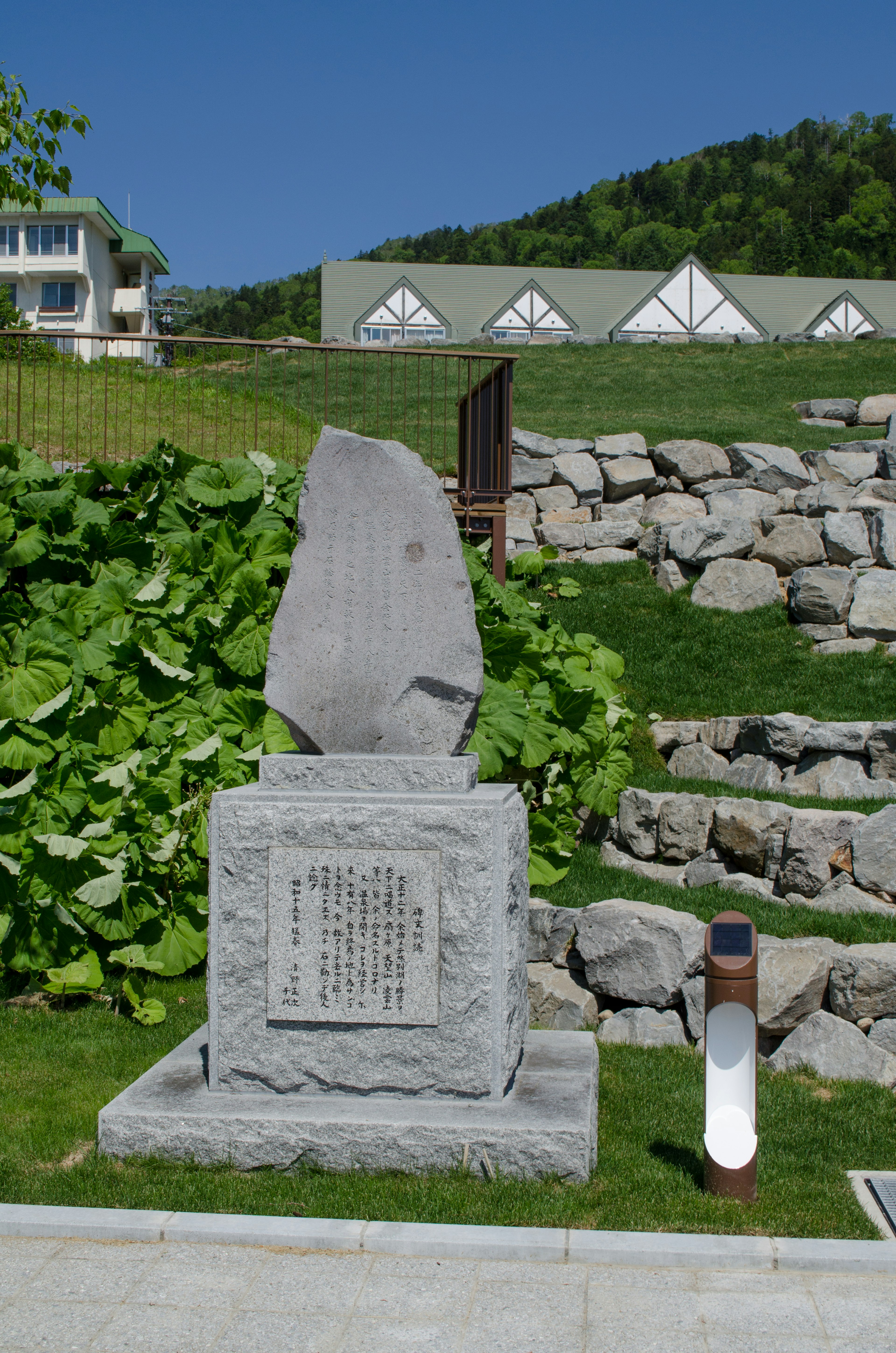 Stone monument surrounded by greenery