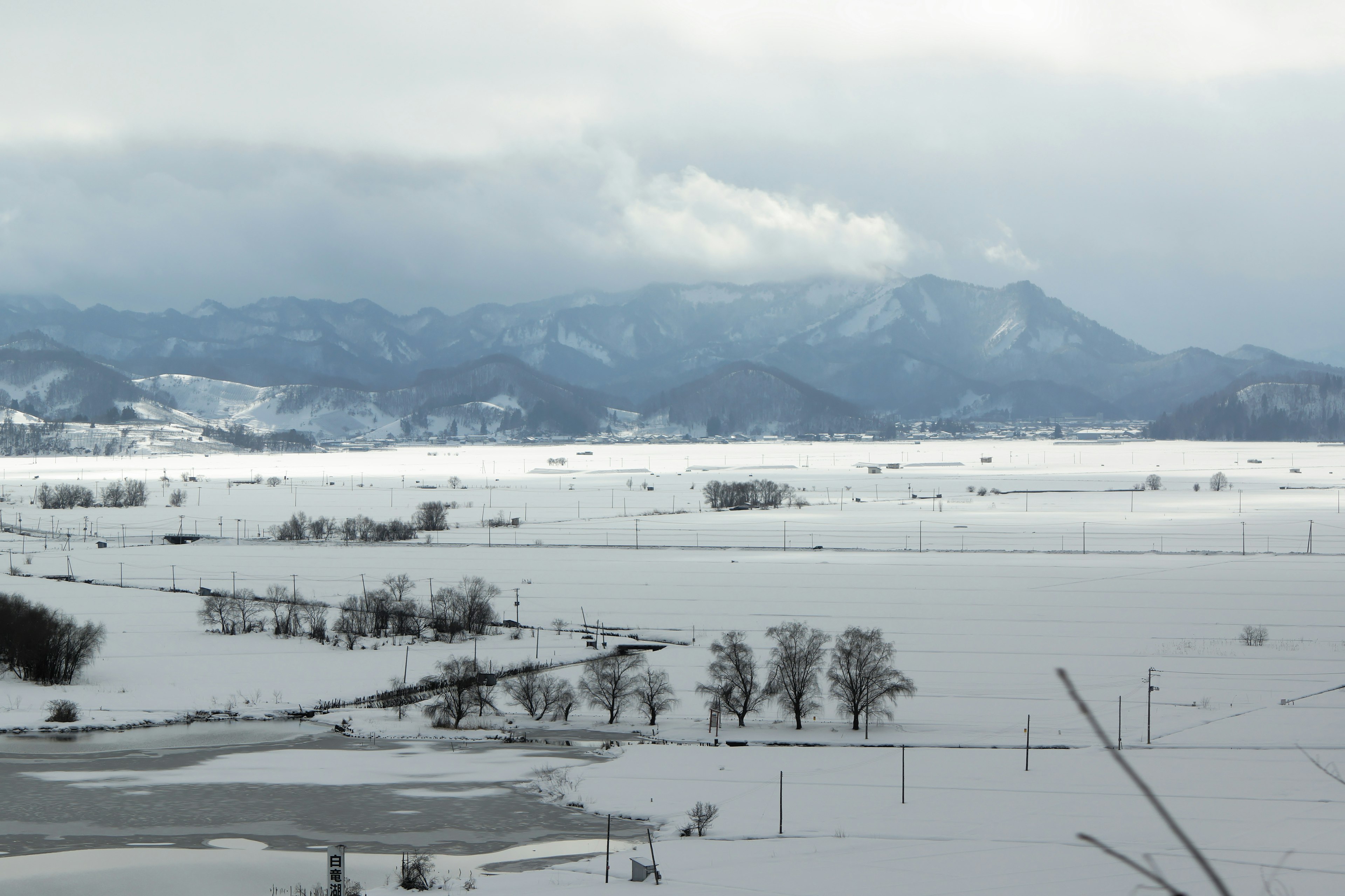 Snow-covered landscape with mountains in the background