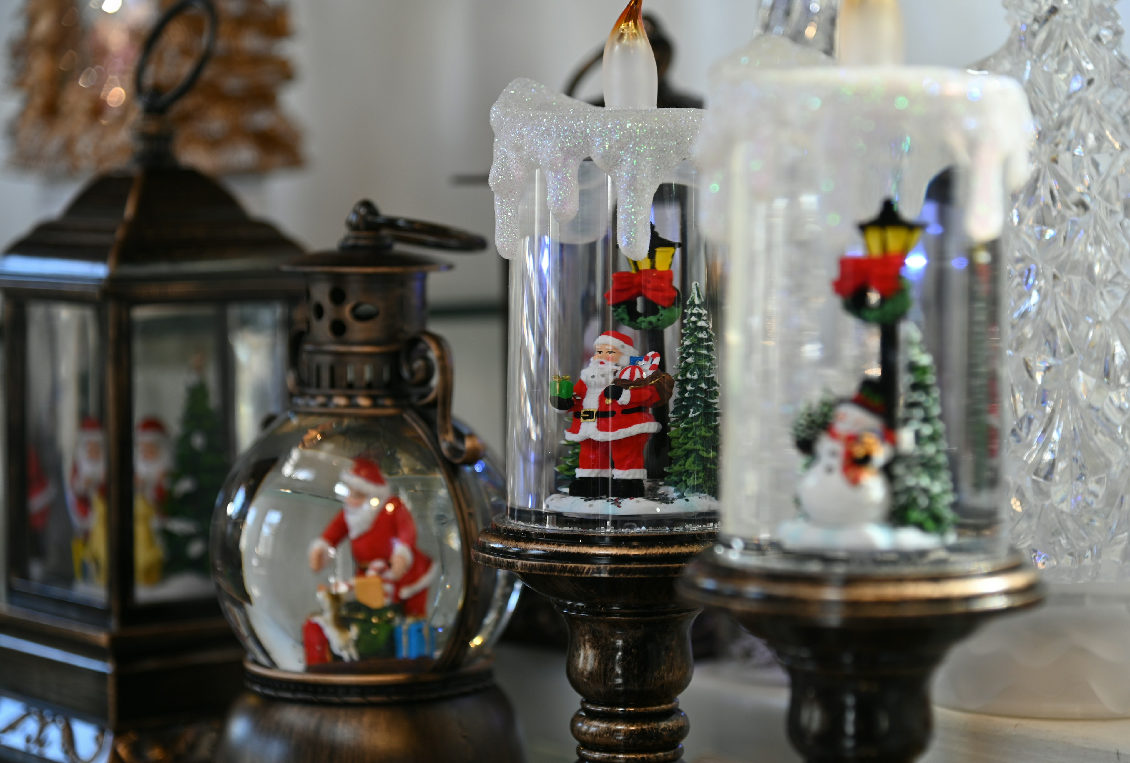 Collection of Christmas decorations featuring Santa Claus figurines