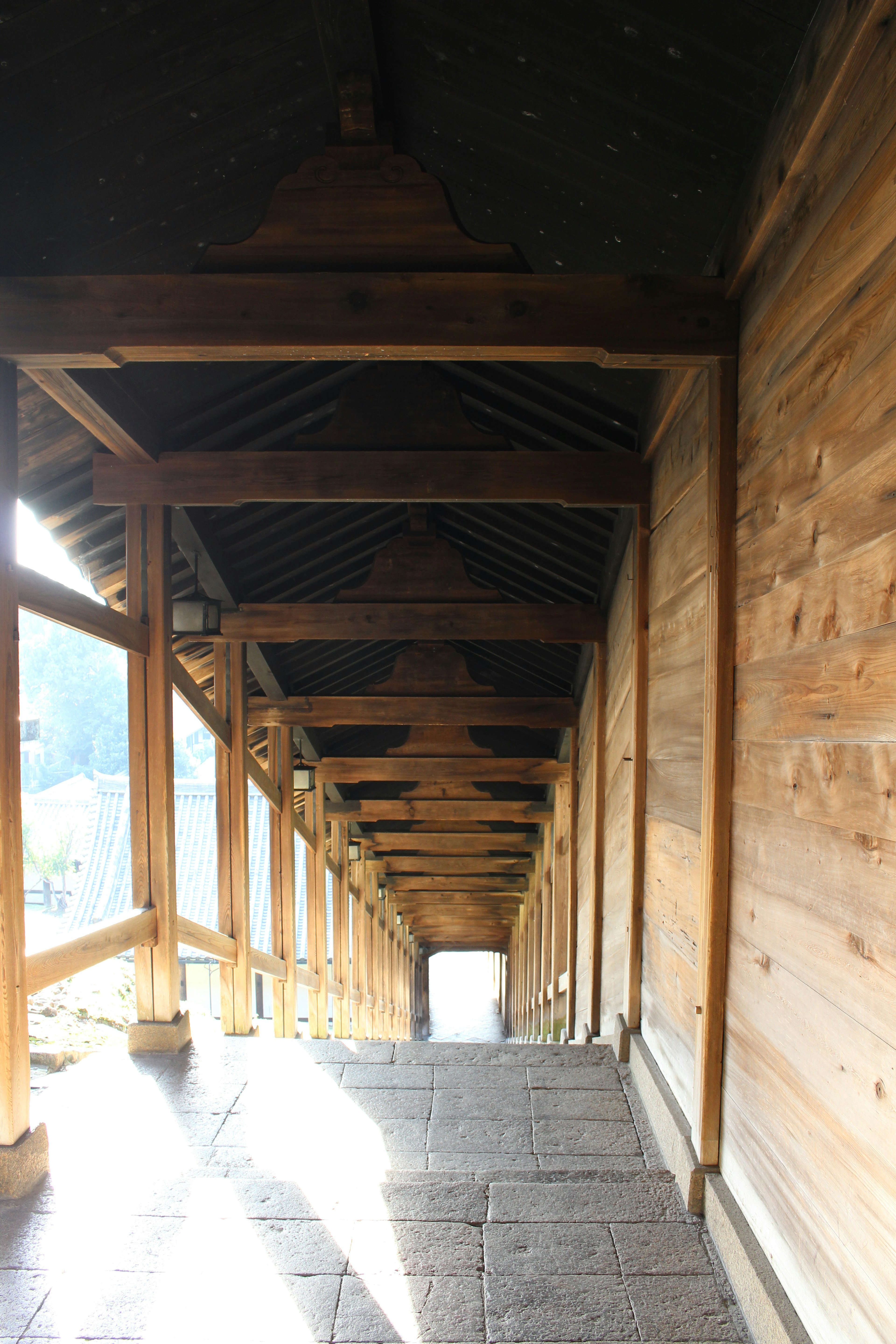 Wooden arcade stairs leading down with light and shadow