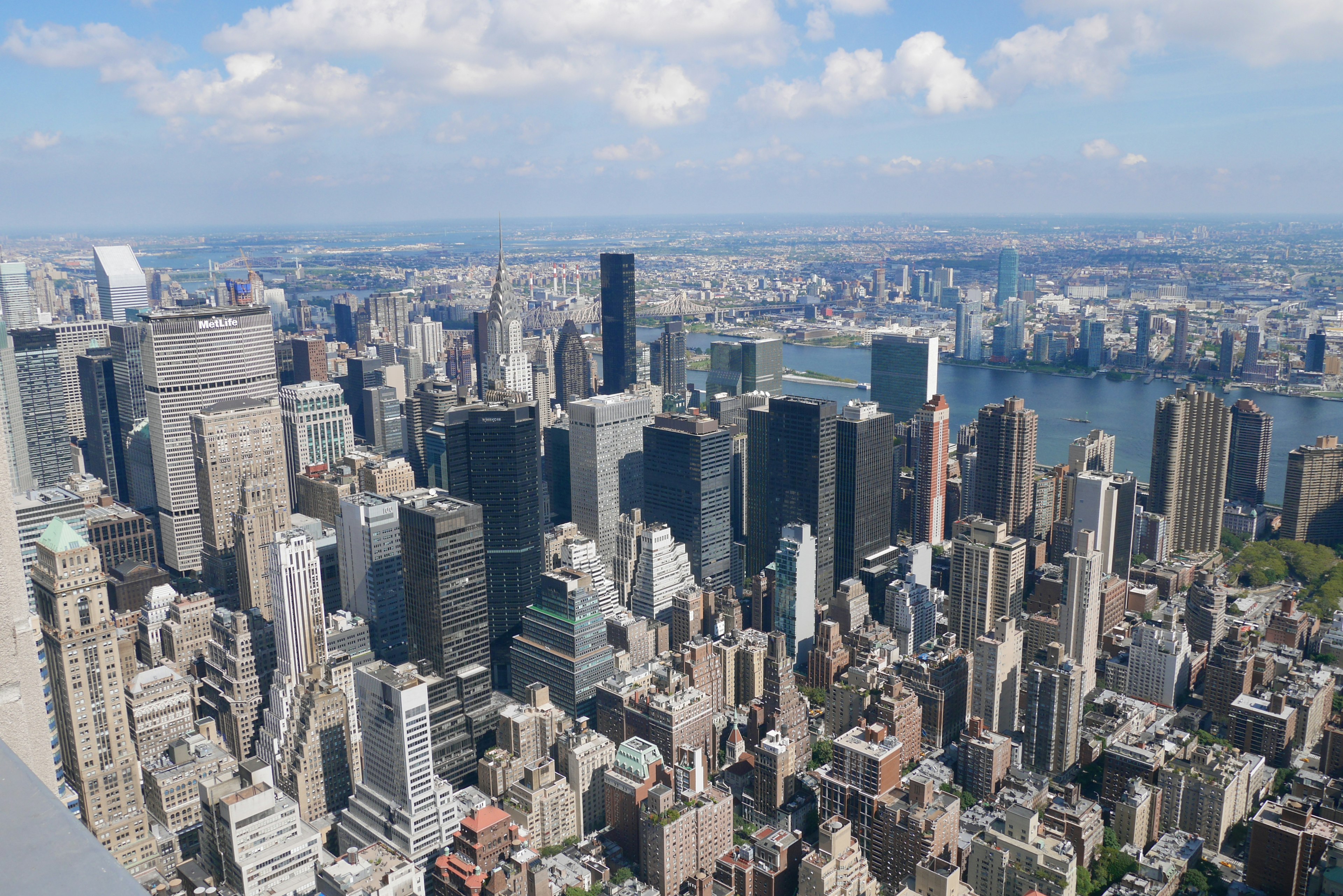 Aerial view of New York City skyline featuring tall skyscrapers and blue sky