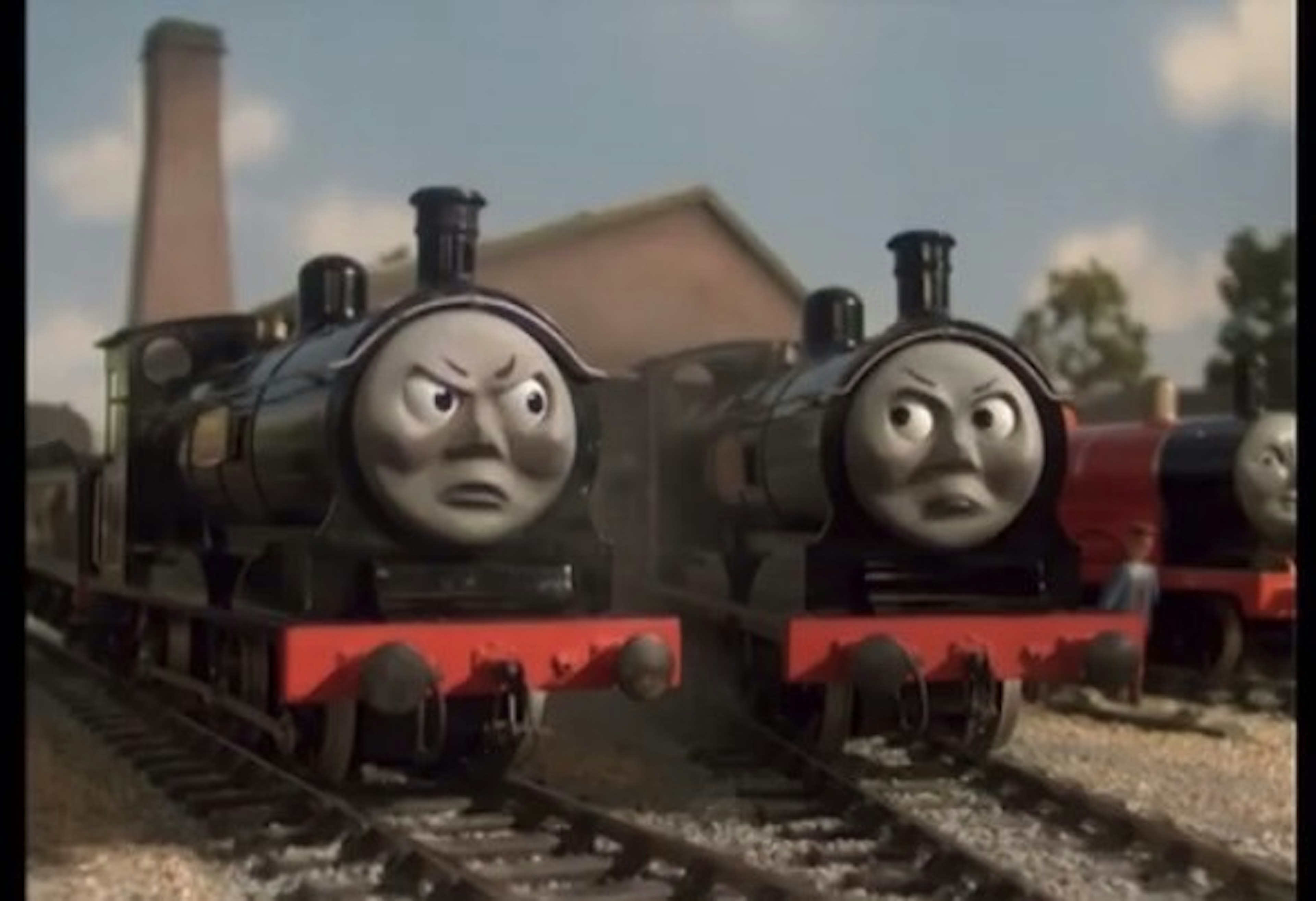 Two railway engines on tracks with stern expressions