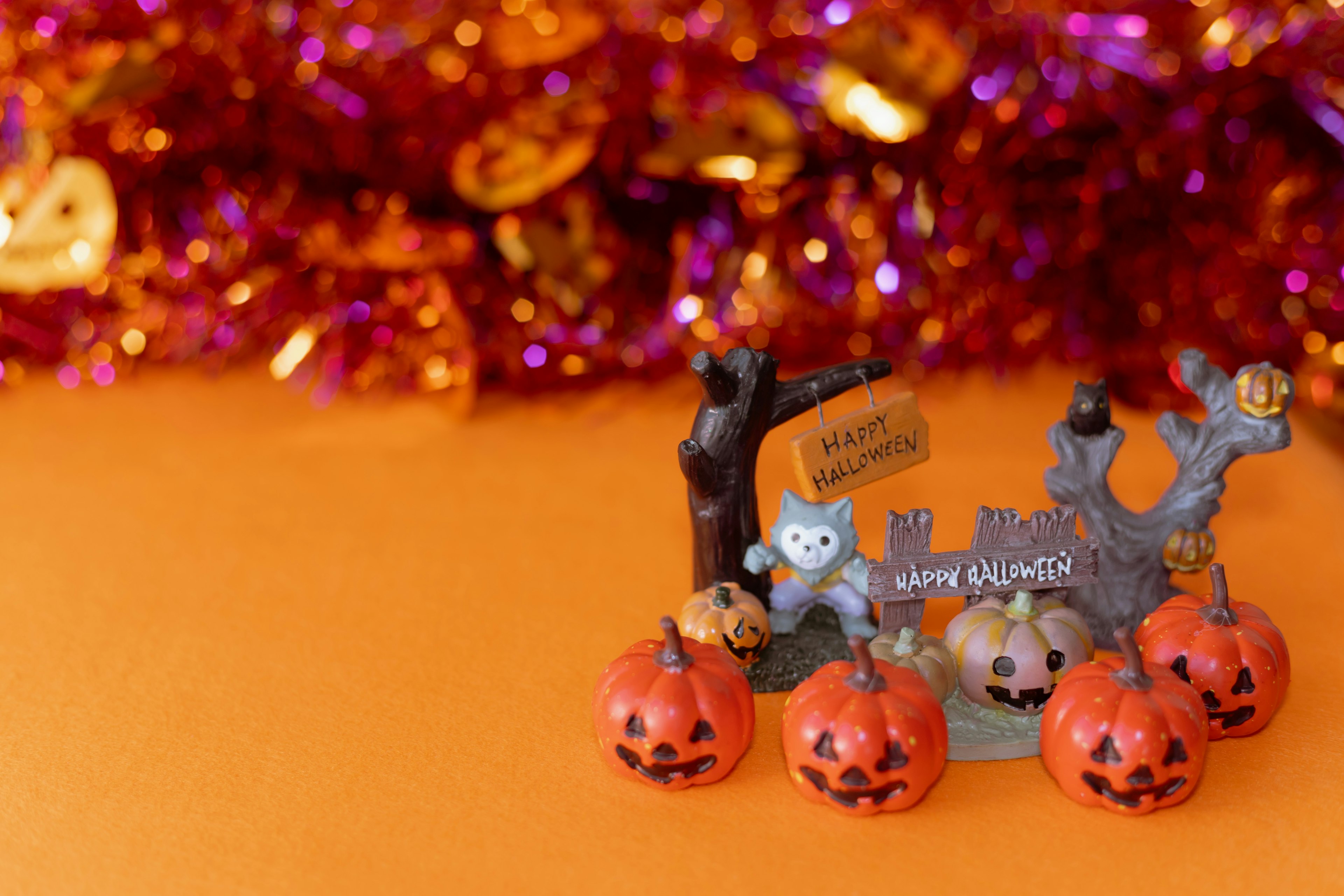 Halloween decorations featuring cute ghosts and pumpkins on an orange background