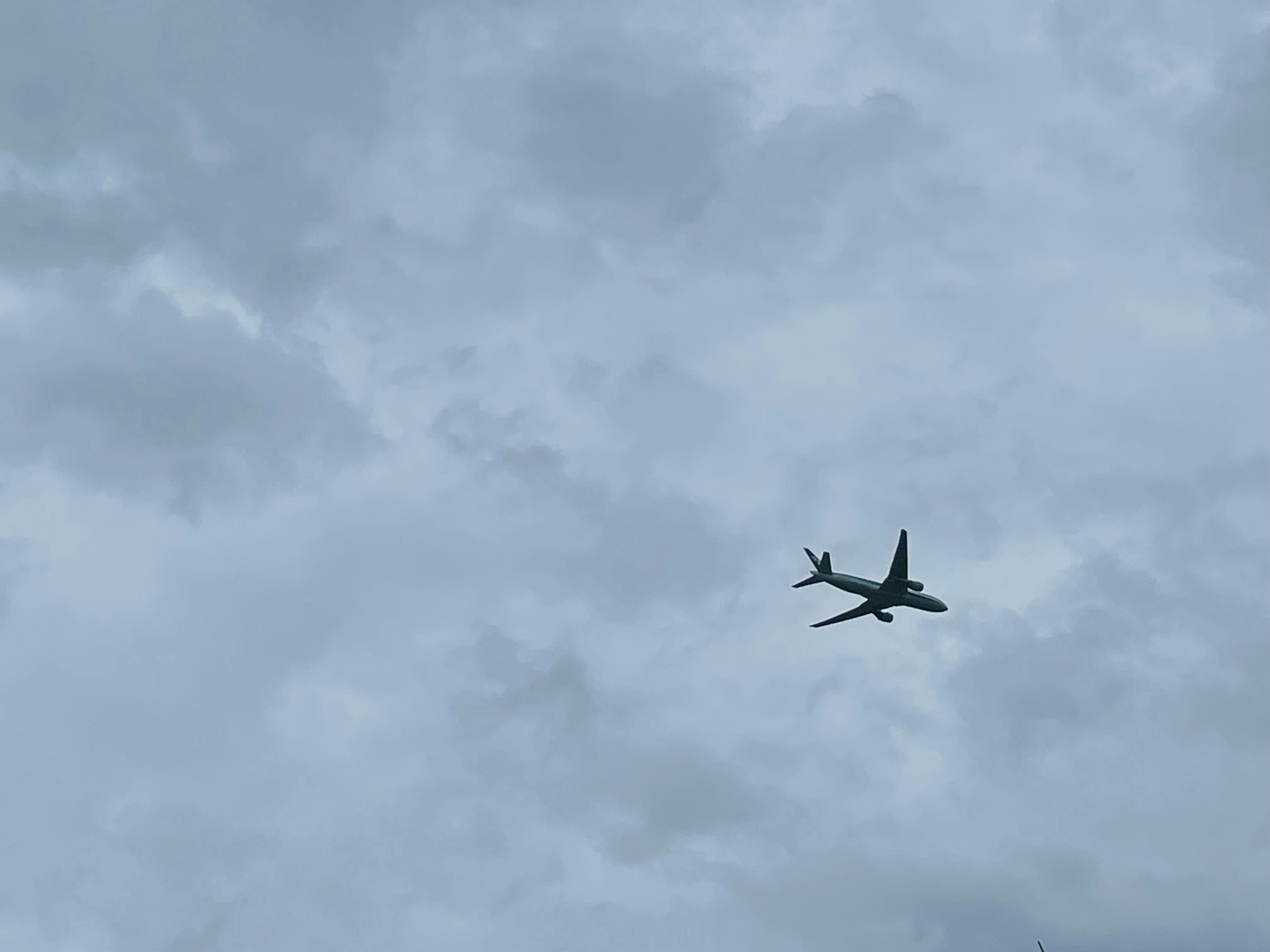 Airplane flying through cloudy sky