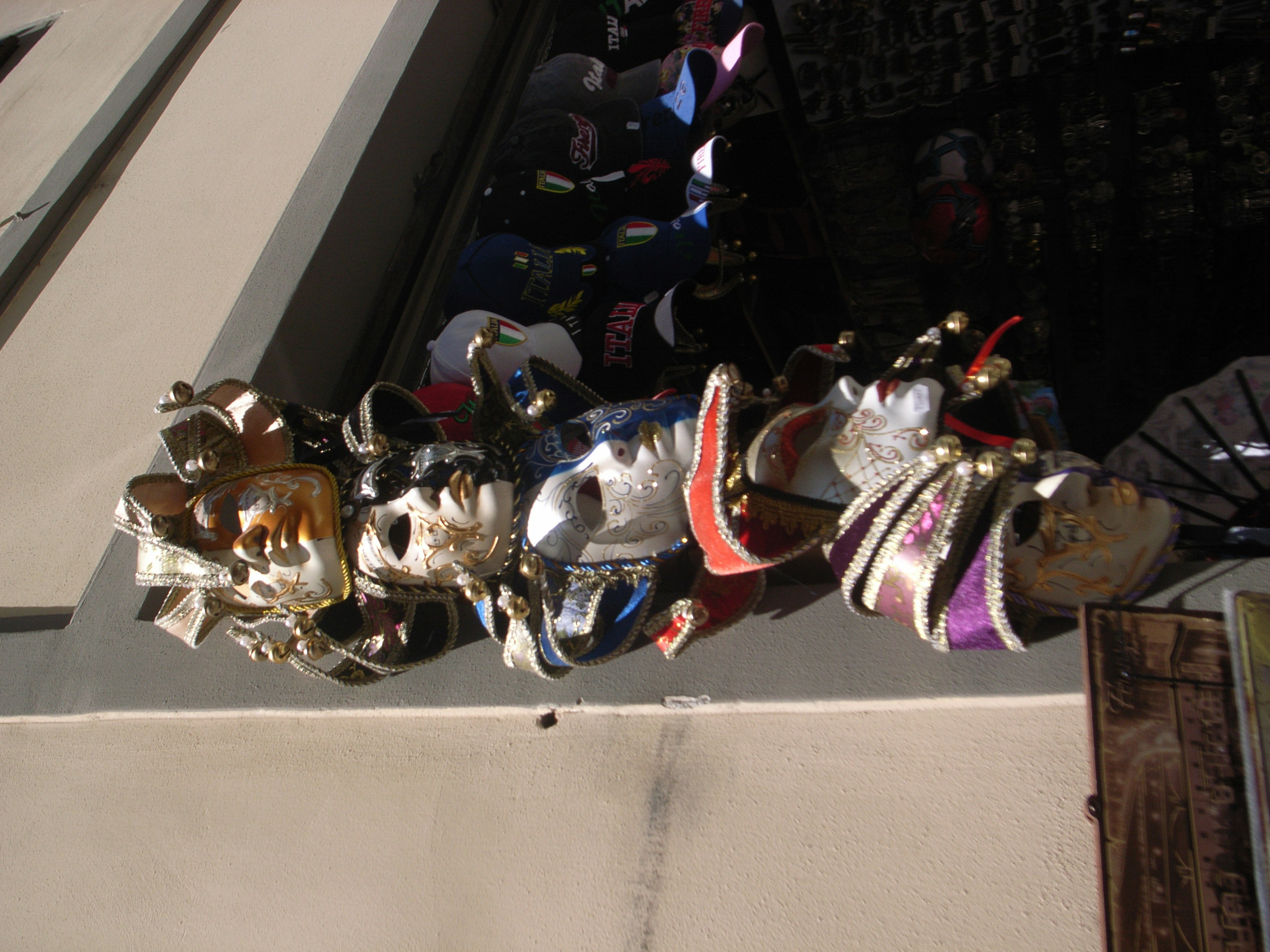 A display of colorful masks hanging on a wall