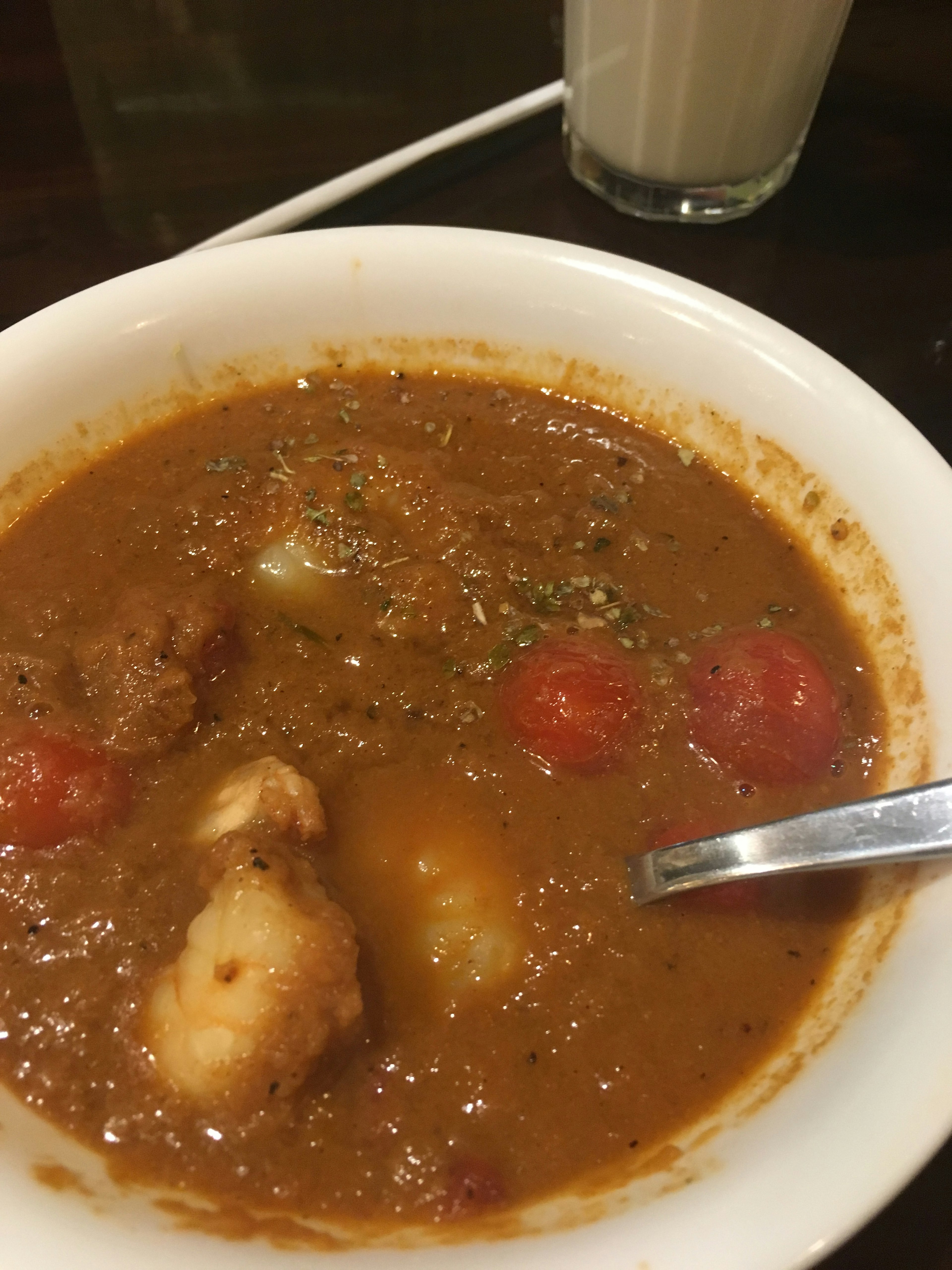 Bowl of spicy curry with chicken and tomatoes