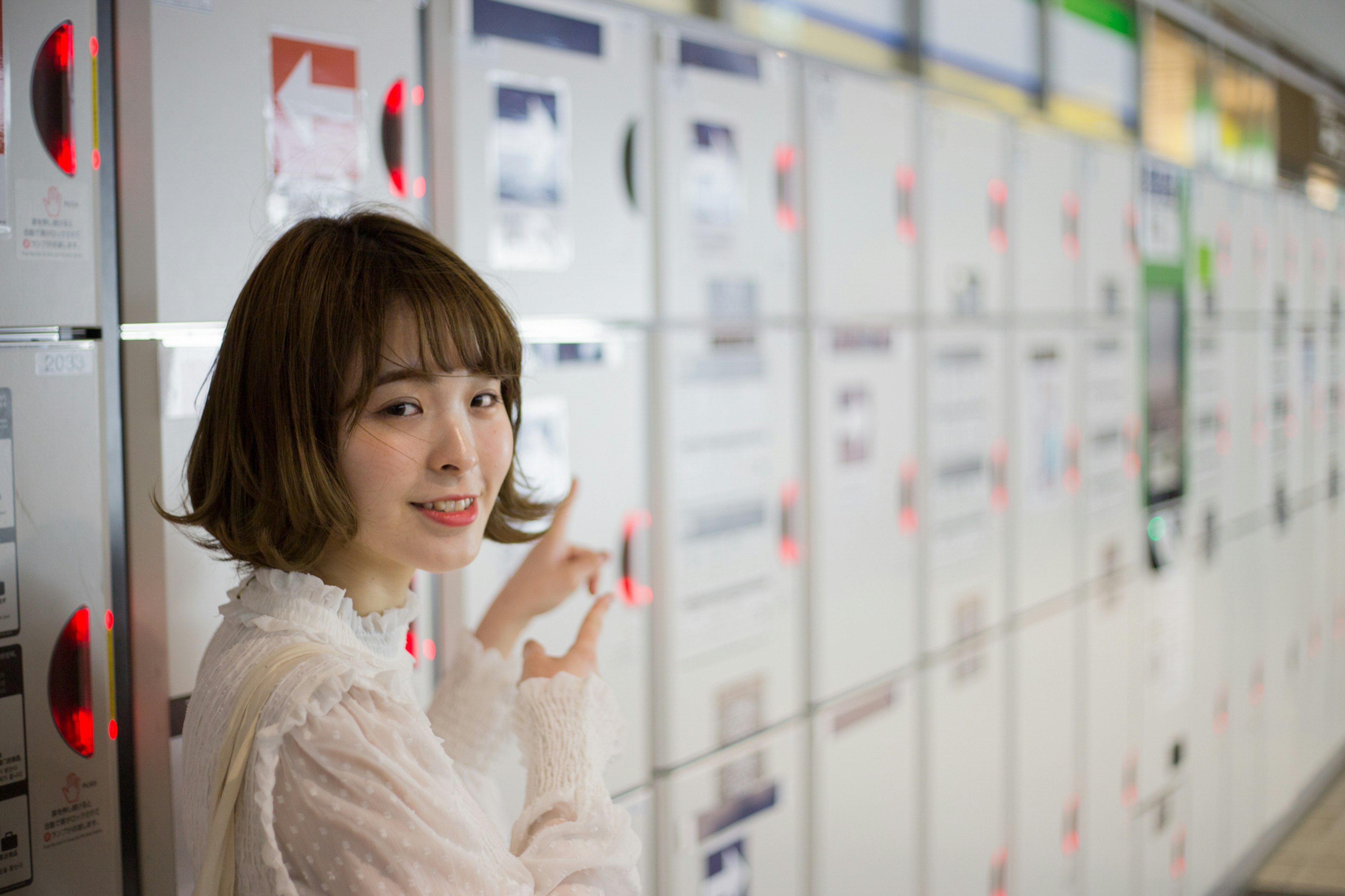 A woman smiling in front of lockers